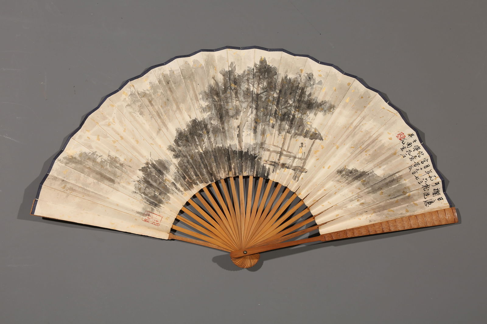 A PAPER FAN PAINTED BY FU BAOSHI WITH LANDSCAPE AND FIGURES.傅抱石: paper fan painted by Fu Baoshi with landscape and figures.傅抱石