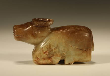 A HETIAN JADE CARVING OF A RECLINING OX: Hetian Jade Carving of a Reclining Ox