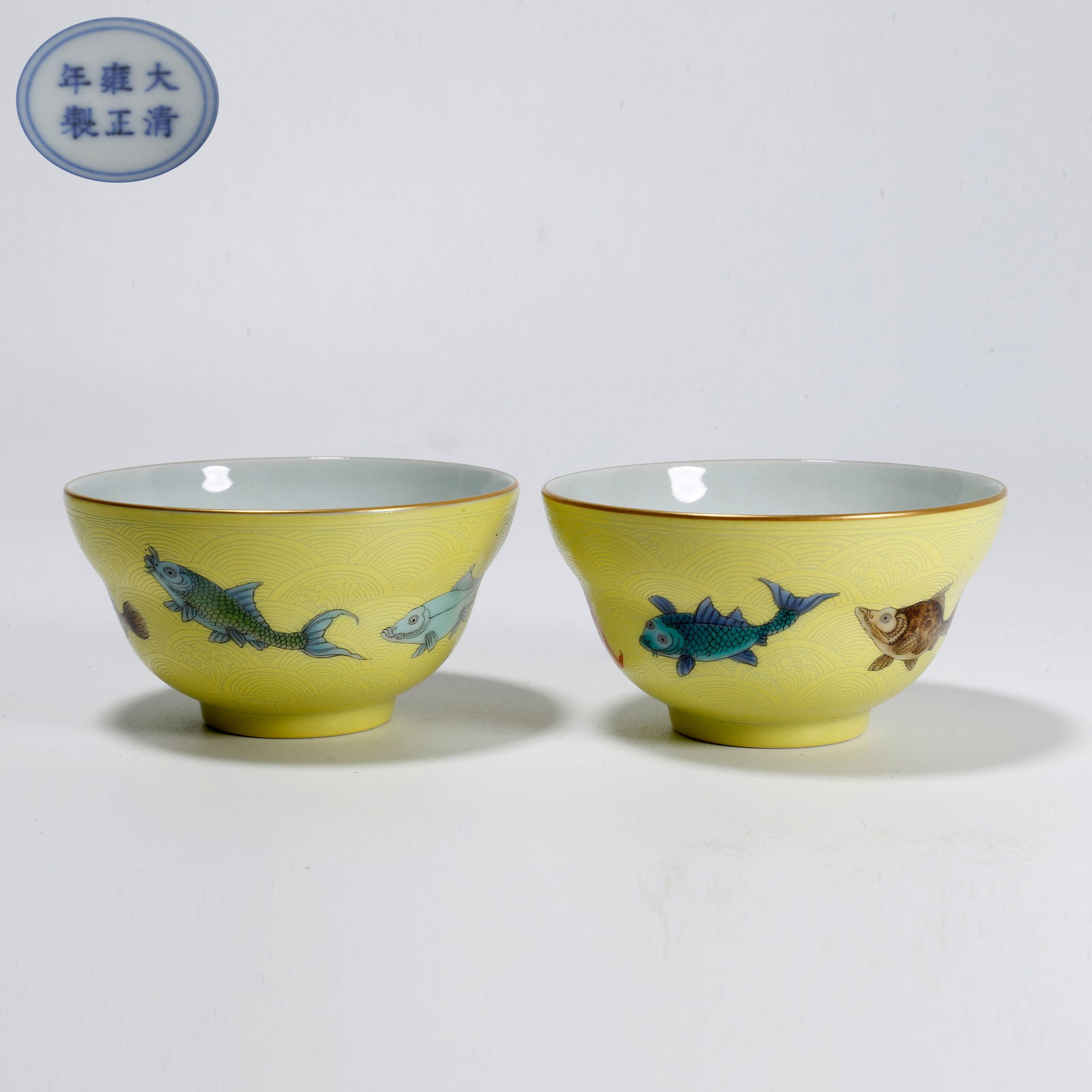 A PAIR OF YELLOW GLAZE CUPS WITH FIVE FISH MOTIF: Pair of yellow glaze cups with five fish motif