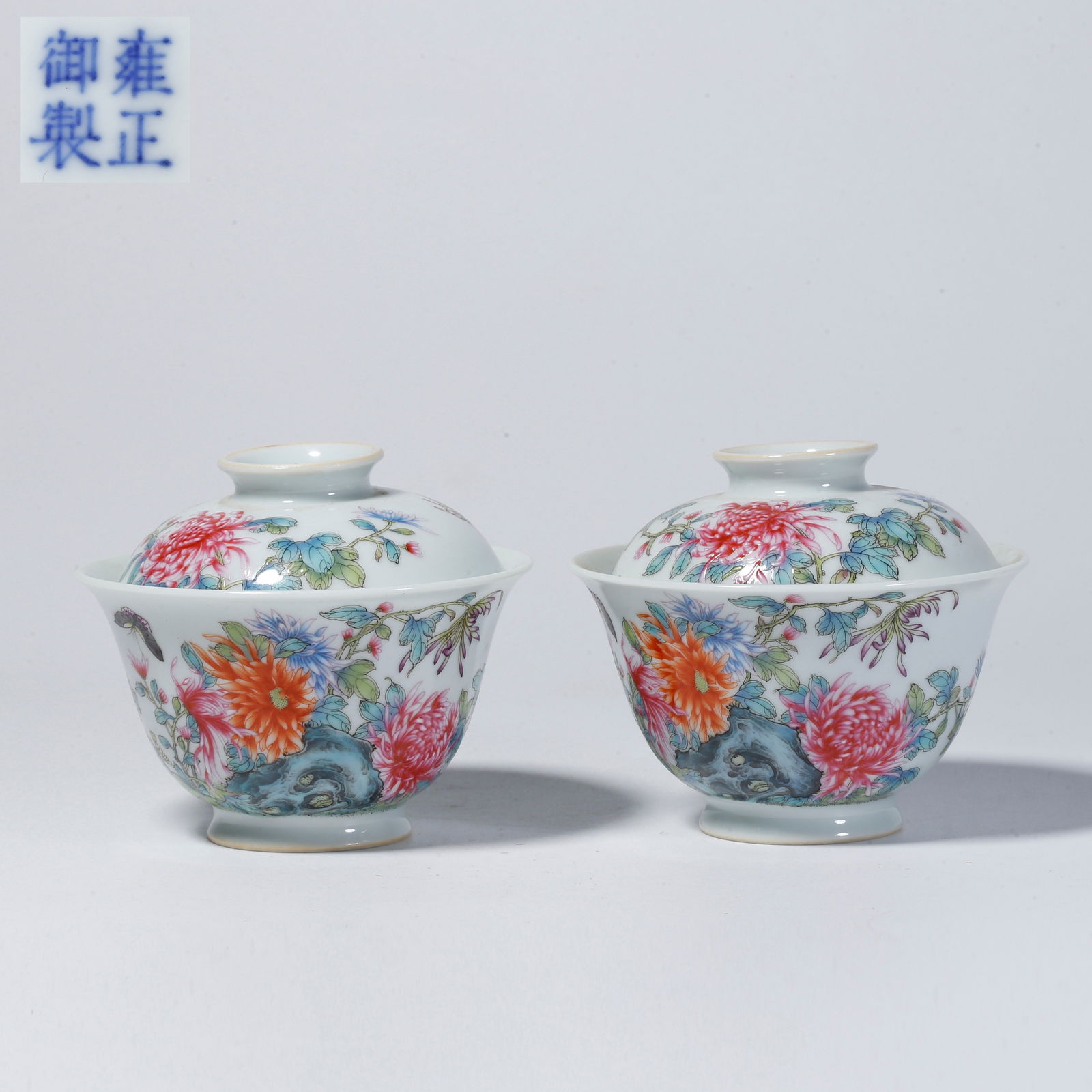 A PAIR OF FAMILLE-ROSE TEA CUPS WITH FLOWER AND DISH DESIGN: Pair of famille-rose tea cups with flower and dish design