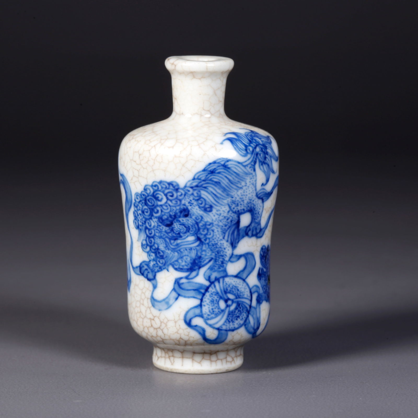 A BLUE AND WHITE LION PLAYING WITH EMBROIDERED BALL PATTERN SNUFF BOTTLE: Blue and White Lion Playing with Embroidered Ball Pattern Snuff Bottle