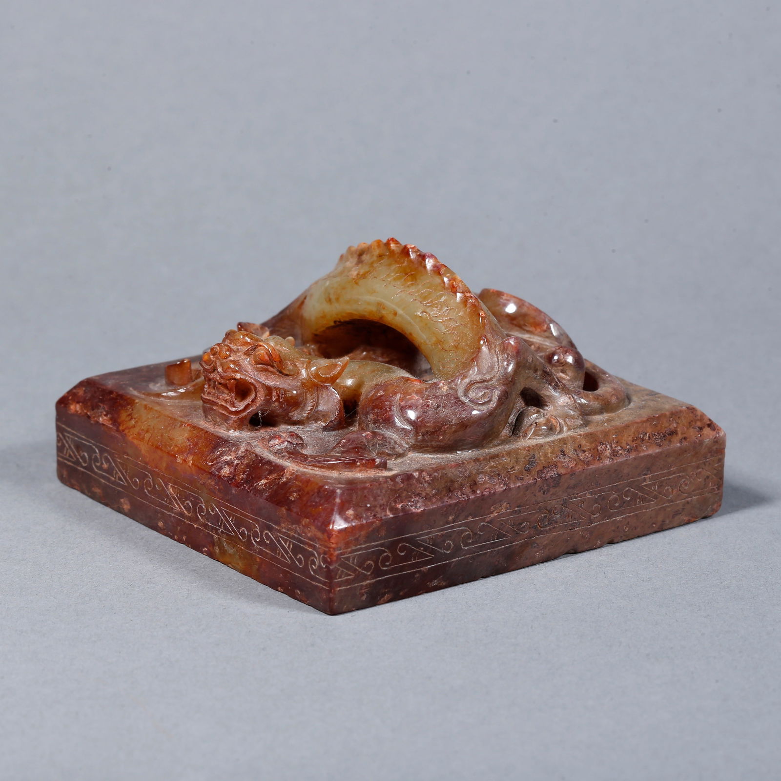 A HETIAN JADE CARVED SEAL WITH DRAGON-FORM FINIAL: Hetian jade carved seal with dragon-form finial