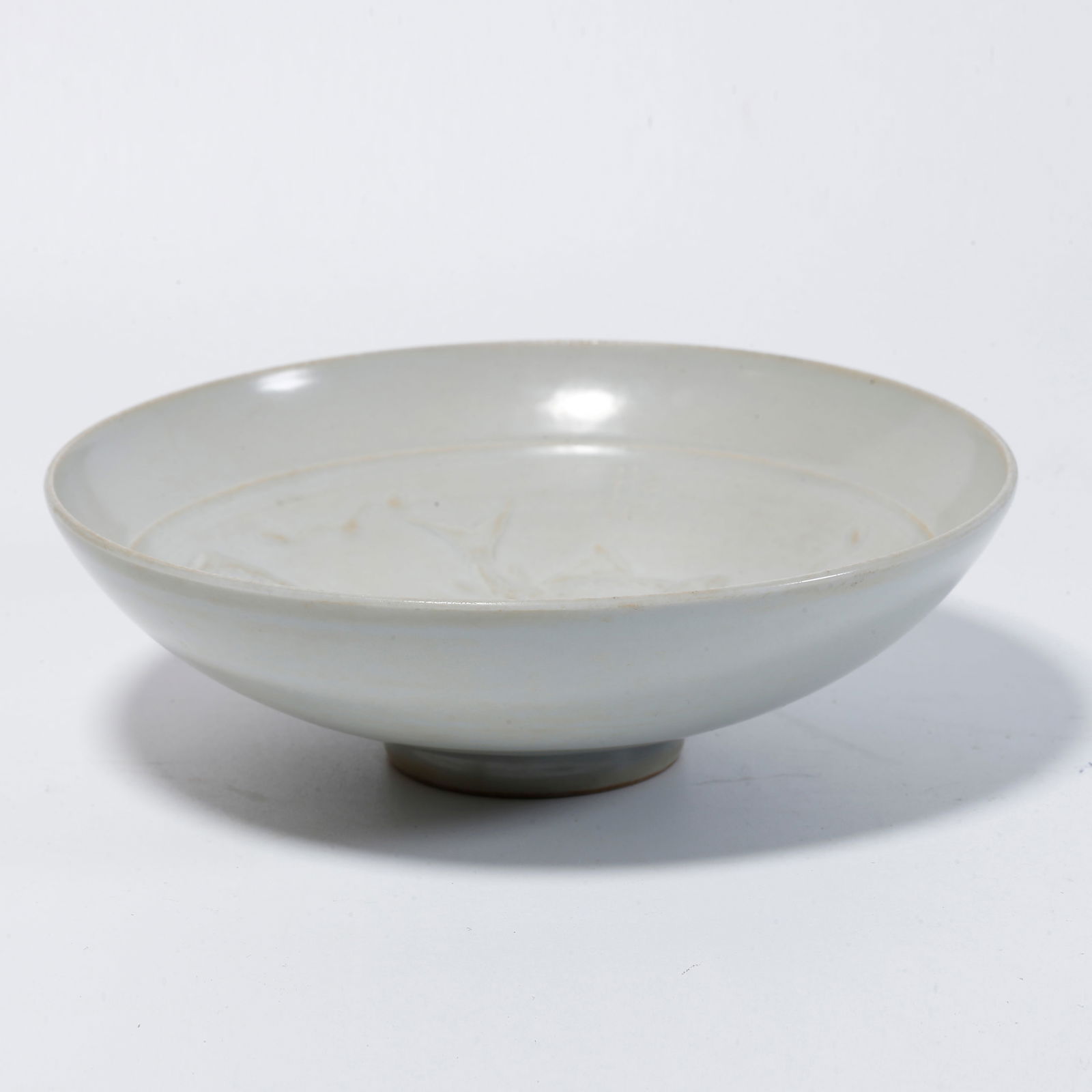 A WHITE-GLAZED BOWL WITH FISH DESIGN: White-glazed bowl with fish design