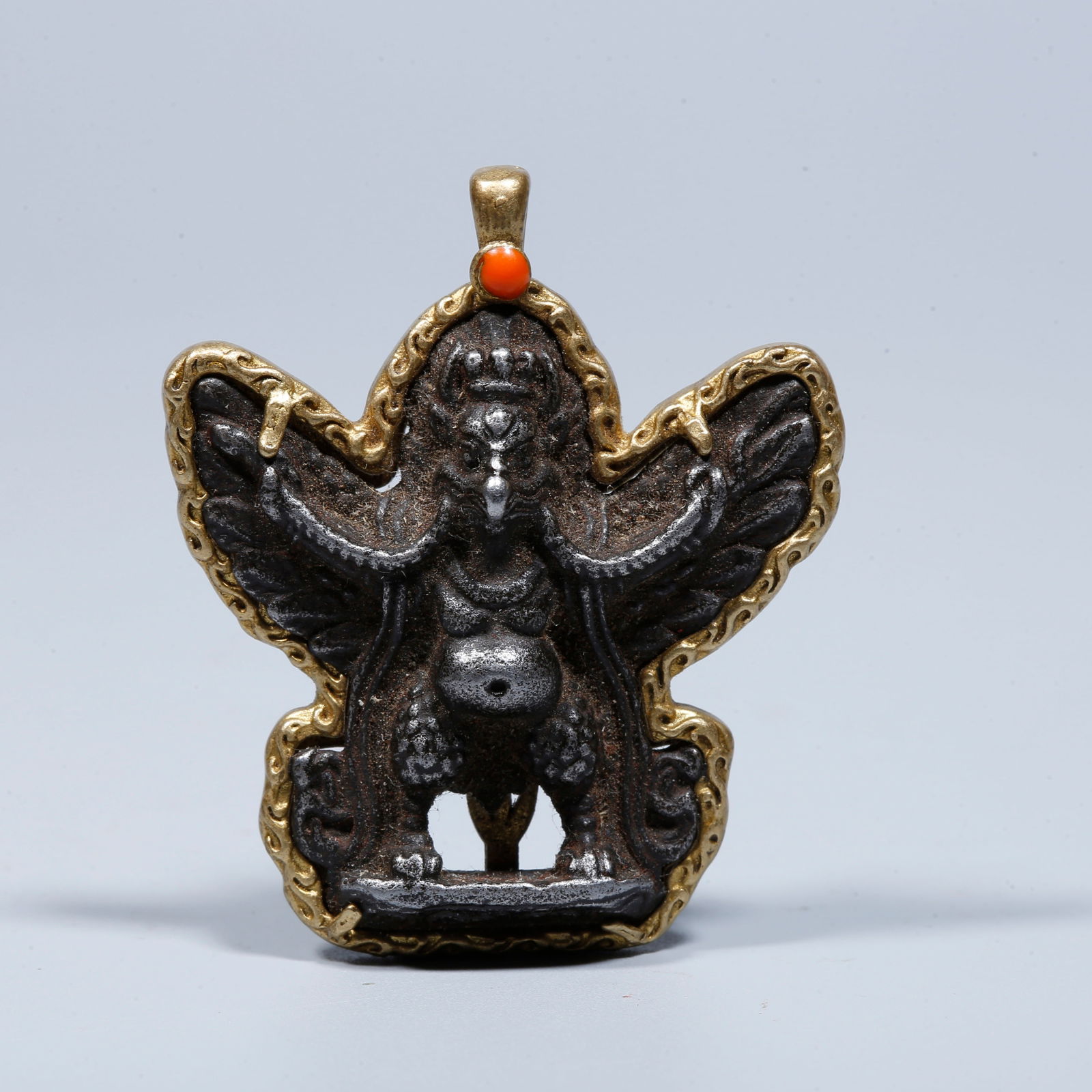 A IRON WITH GOLD-INLAY GREAT ROC BIRD PENDANT: Iron with gold-inlay great roc bird pendant