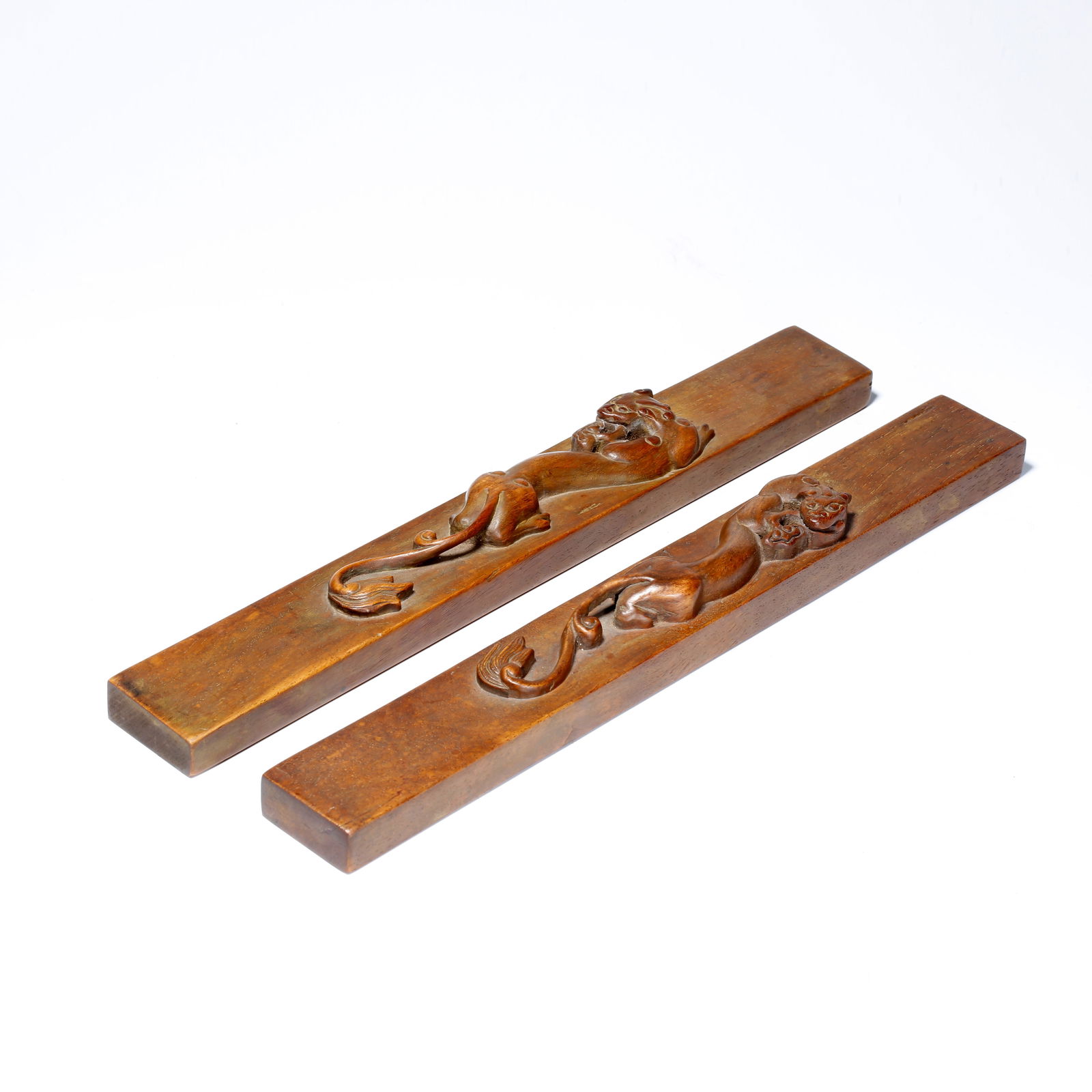 A PAIR OF HUANGHUALI WOOD CARVED PAPERWEIGHTS WITH CHILONG PATTERN: Pair of Huanghuali Wood Carved Paperweights with Chilong Pattern