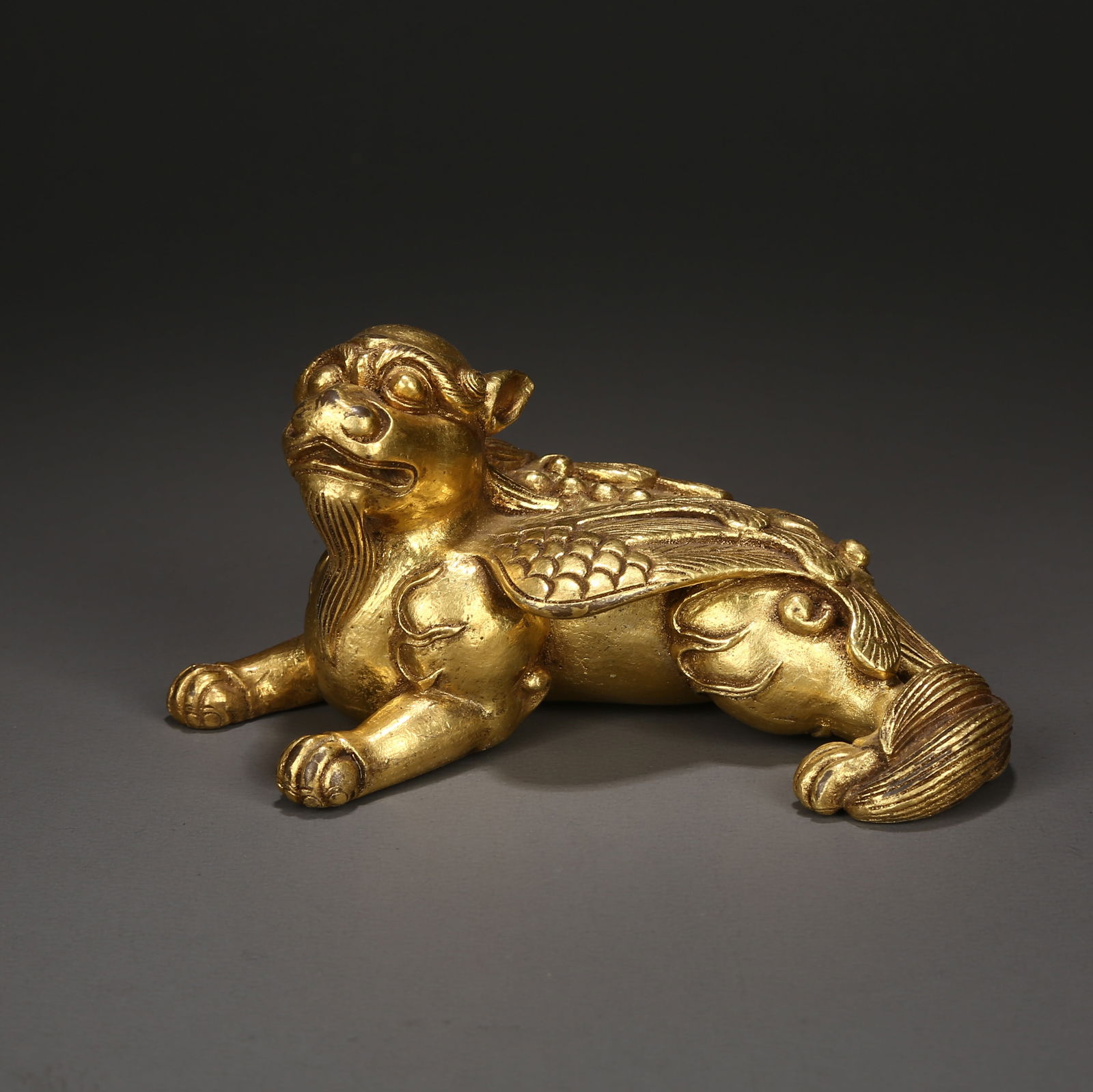A GILDED BRONZE MYTHICAL BEAST PAPERWEIGHT: Gilded bronze mythical beast paperweight
