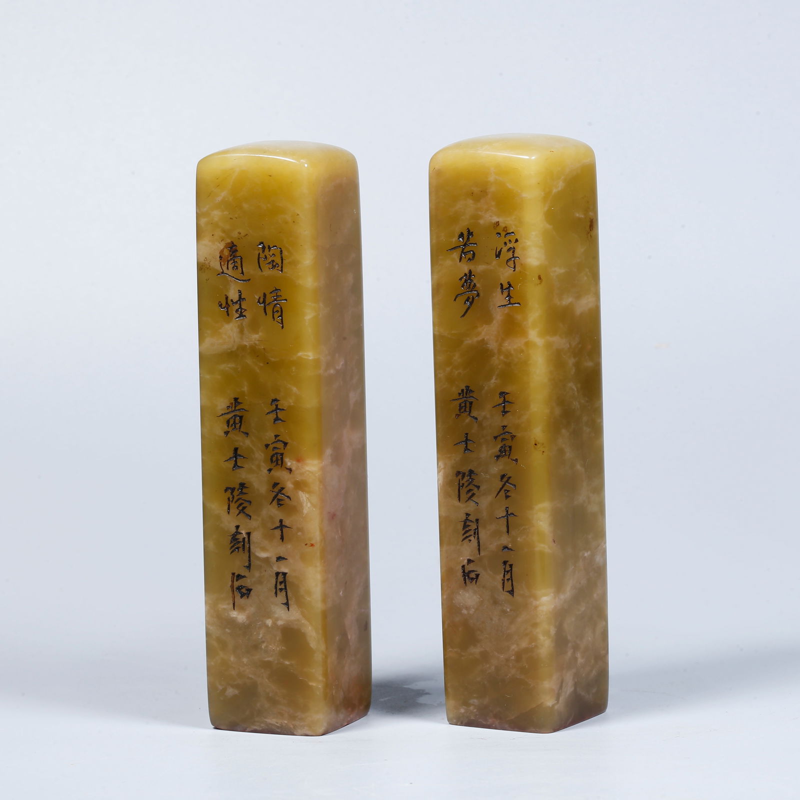 A PAIR OF SHOUSHAN STONE CARVED SEALS WITH INCISED POETRY INSCRIPTION: Pair of Shoushan stone carved seals with incised poetry inscription