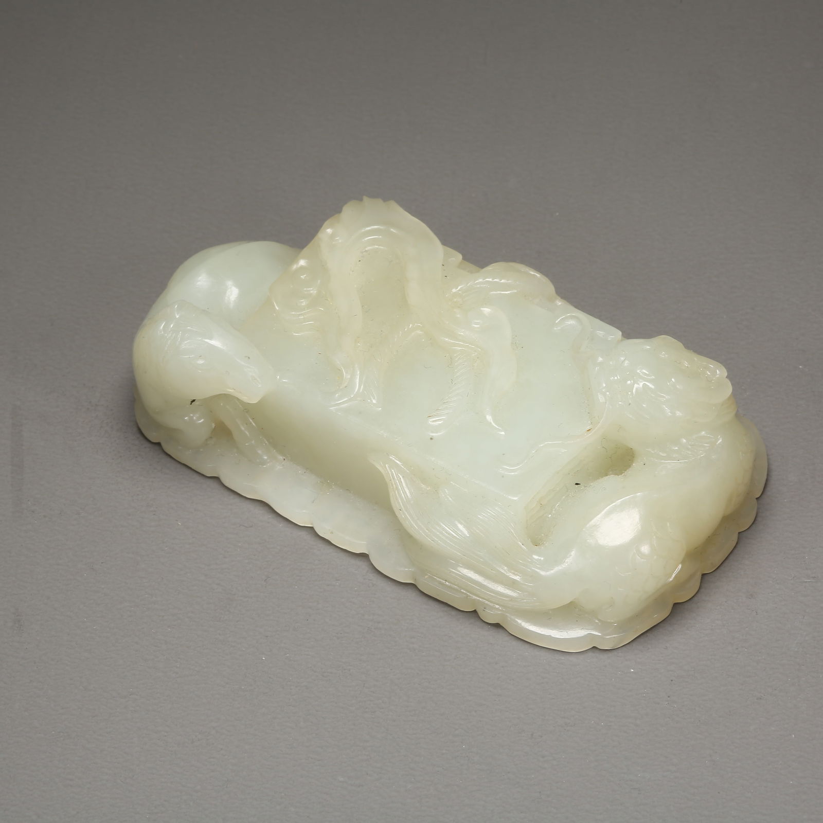 A HETIAN WHITE JADE WHITE HORSE CARRYING SCRIPTURES WITH QILIN PAPERWEIGHT: Hetian White Jade White Horse Carrying Scriptures with Qilin Paperweight