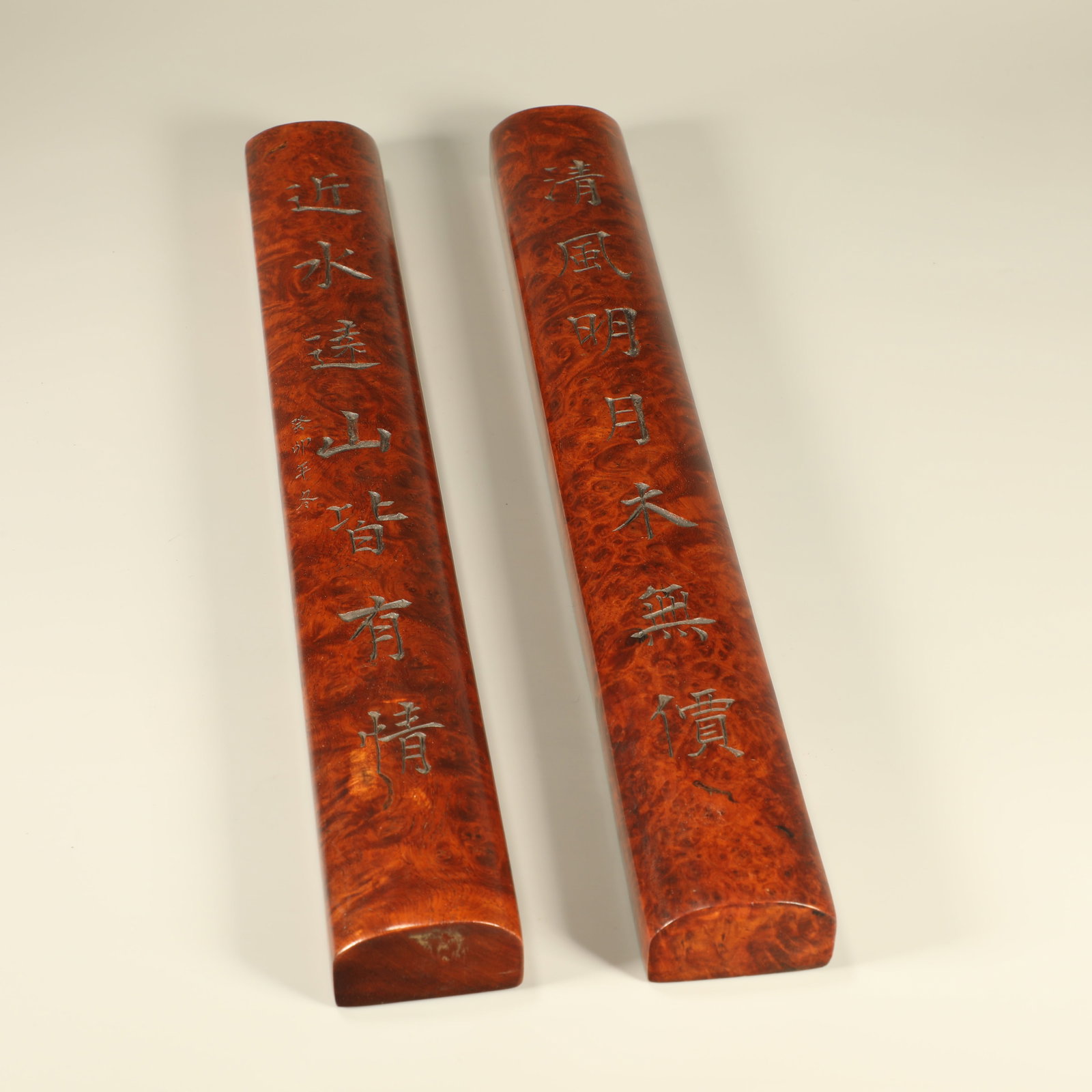 A HUANGHUALI AND CHERRYWOOD CARVED PAIR OF PAPERWEIGHTS WITH POETRY INSCRIPTIONS: Huanghuali and cherrywood carved pair of paperweights with poetry inscriptions