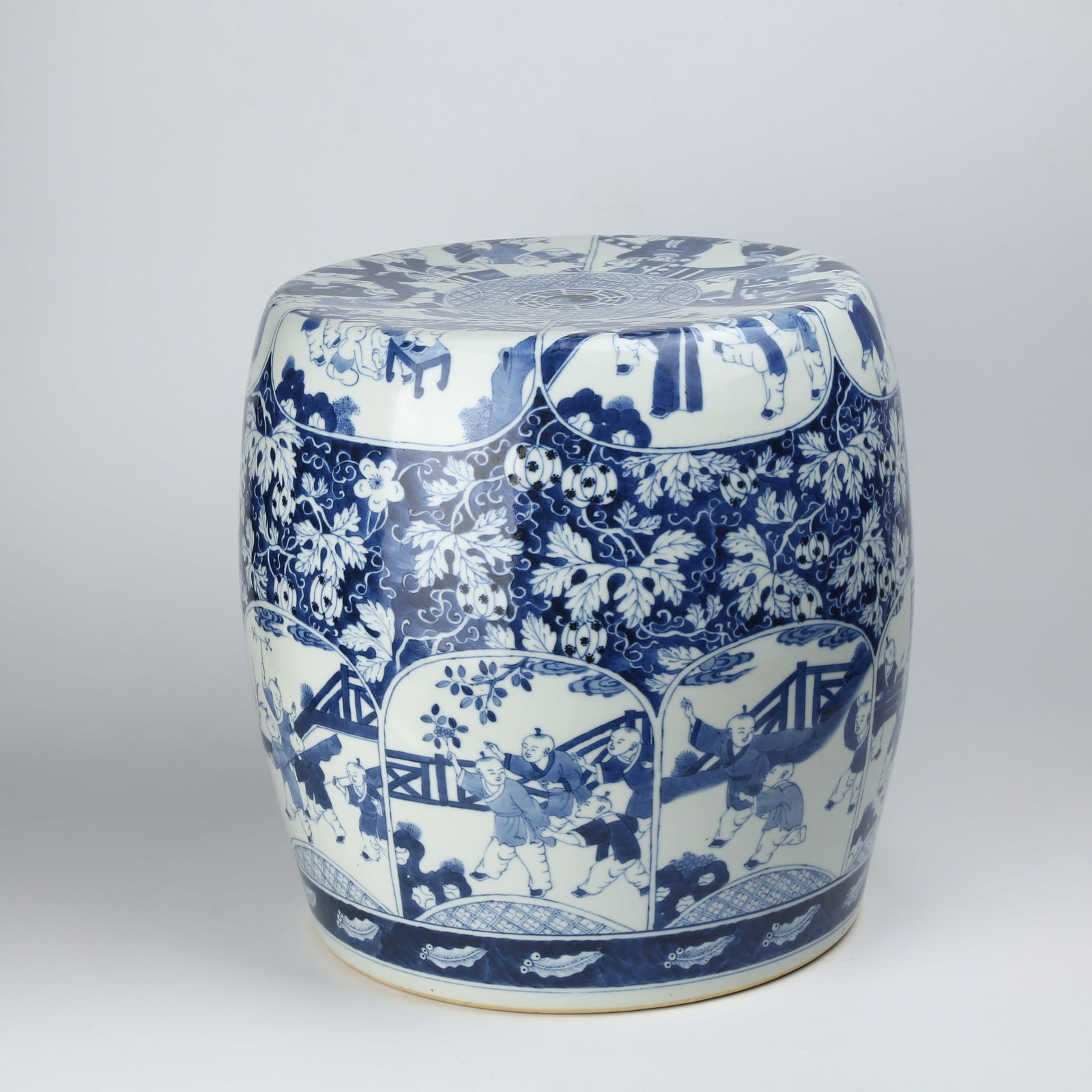 A BLUE-AND-WHITE "HUNDRED BOYS AT PLAY" DRUM STOOL: Blue-and-white "Hundred Boys at Play" drum stool