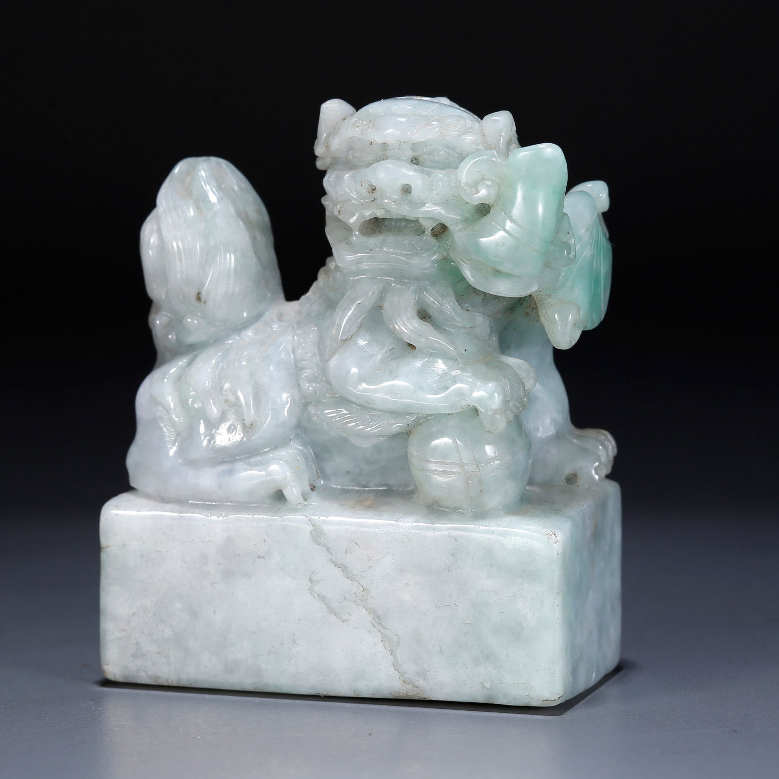 A JADEITE CARVED LION-HEAD PAPERWEIGHT: Jadeite carved lion-head paperweight