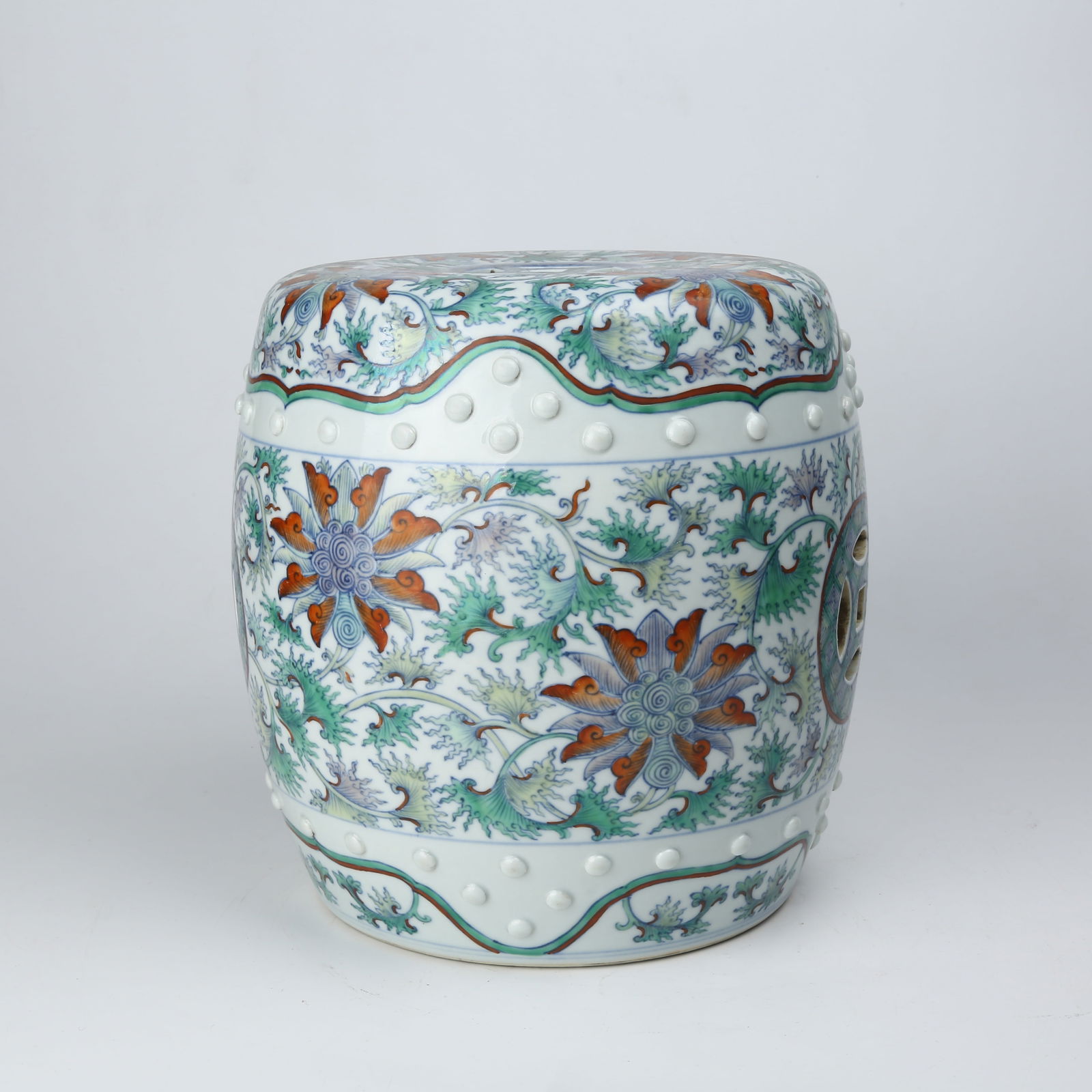 A DOUCAI DRUM STOOL WITH ENTWINED FLORAL PATTERN: Doucai drum stool with entwined floral pattern