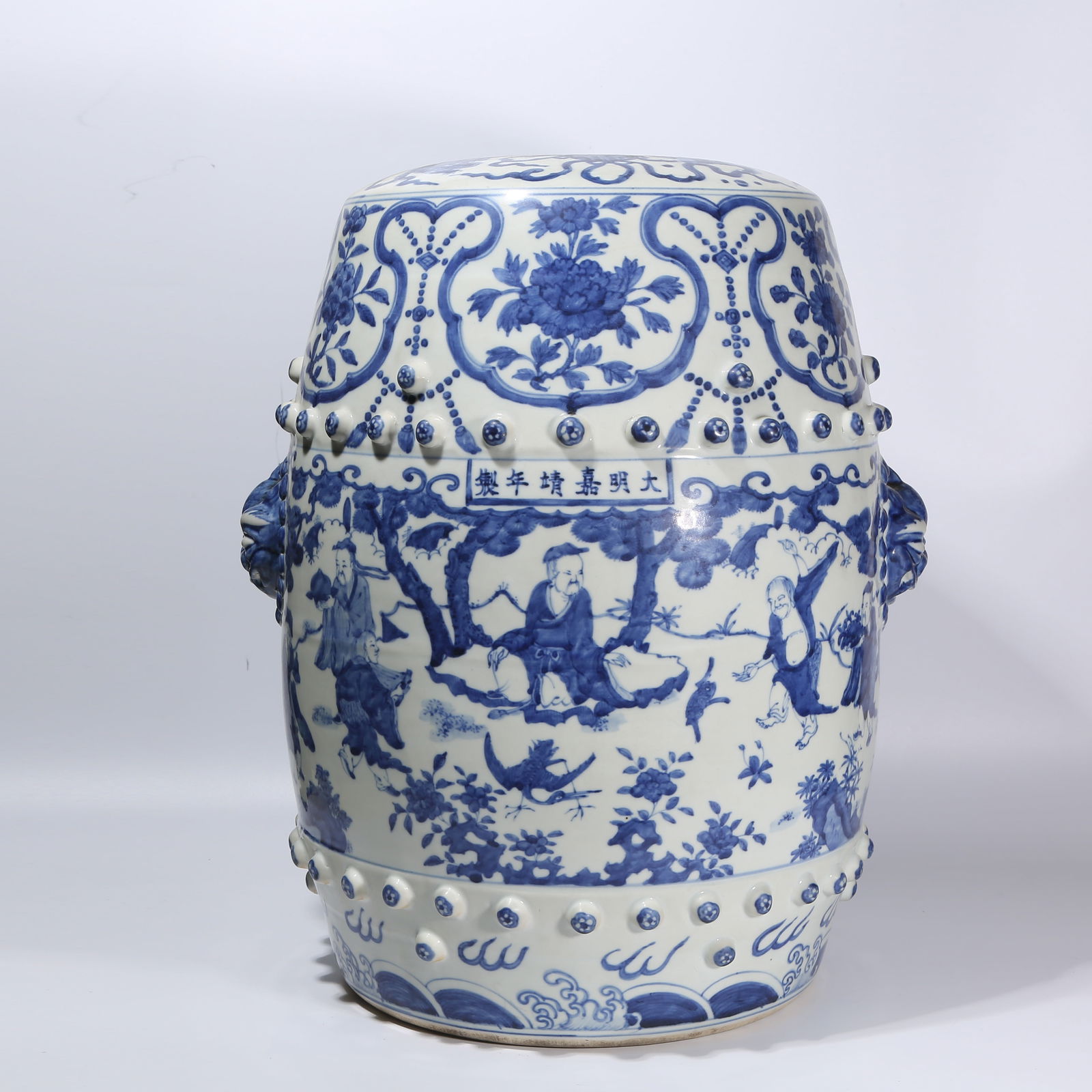 A BLUE AND WHITE DRUM STOOL WITH FIGURES AND STORY DESIGN AND ANIMAL-HEAD HANDLES: Blue and White Drum Stool with Figures and Story Design and Animal-Head Handles