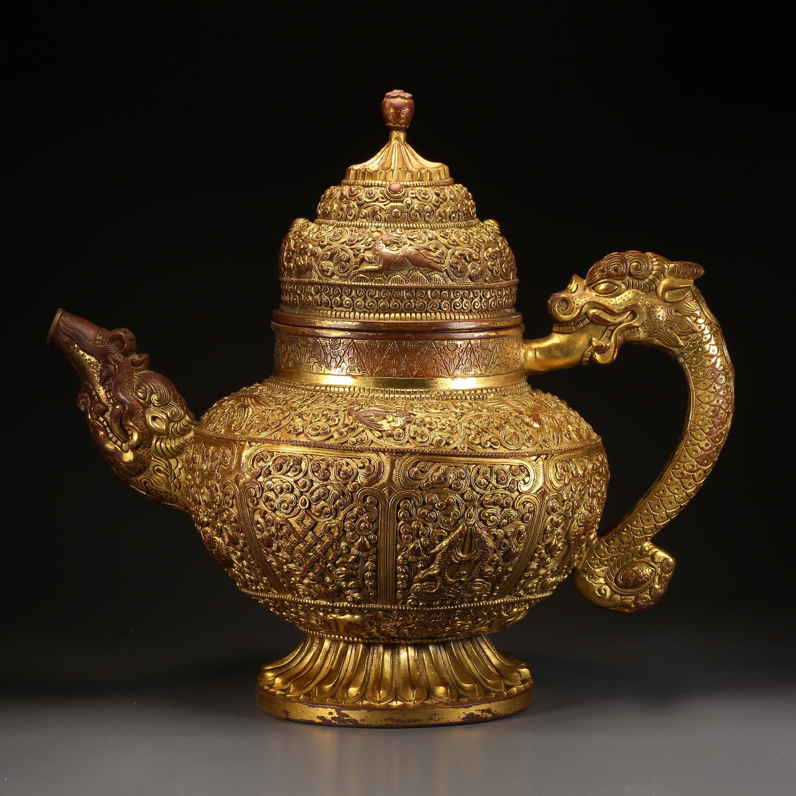 A GILDED BRONZE TEAPOT WITH DRAGON HANDLE AND EIGHT AUSPICIOUS SYMBOLS (1 of 9)