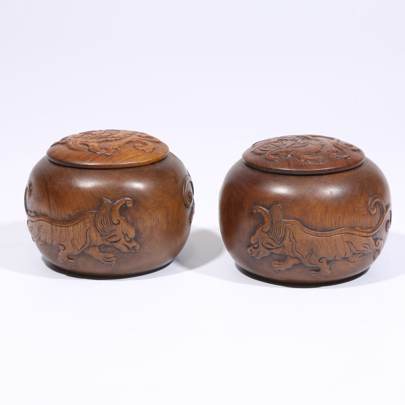 A SET OF HUANGHUALI WOOD GO CONTAINERS WITH AUSPICIOUS BEAST MOTIFS: Set of Huanghuali Wood Go Containers with Auspicious Beast Motifs