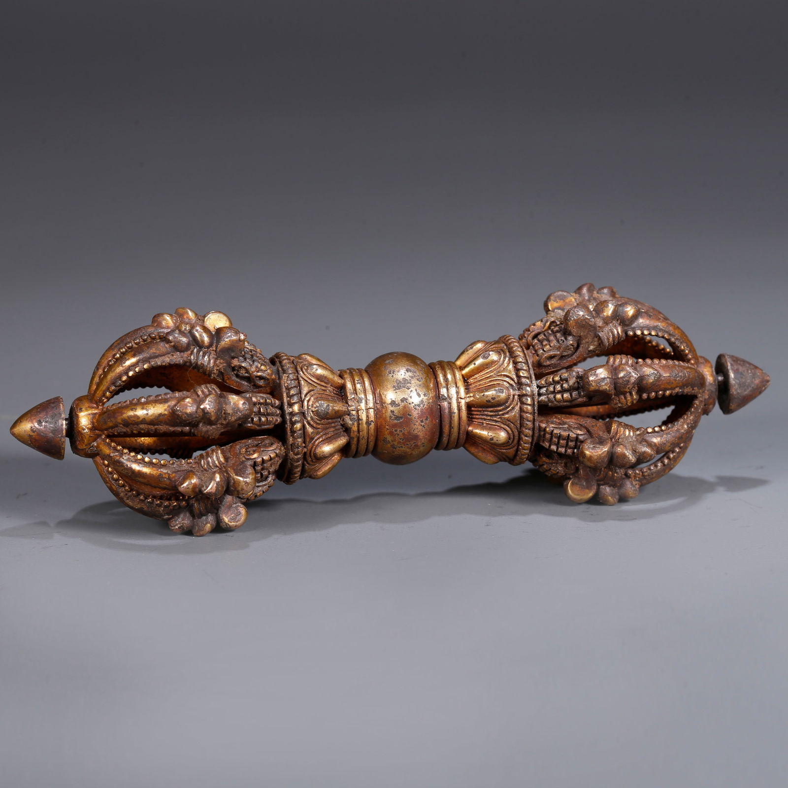 A GILDED BRONZE RITUAL OBJECT (1 of 8)