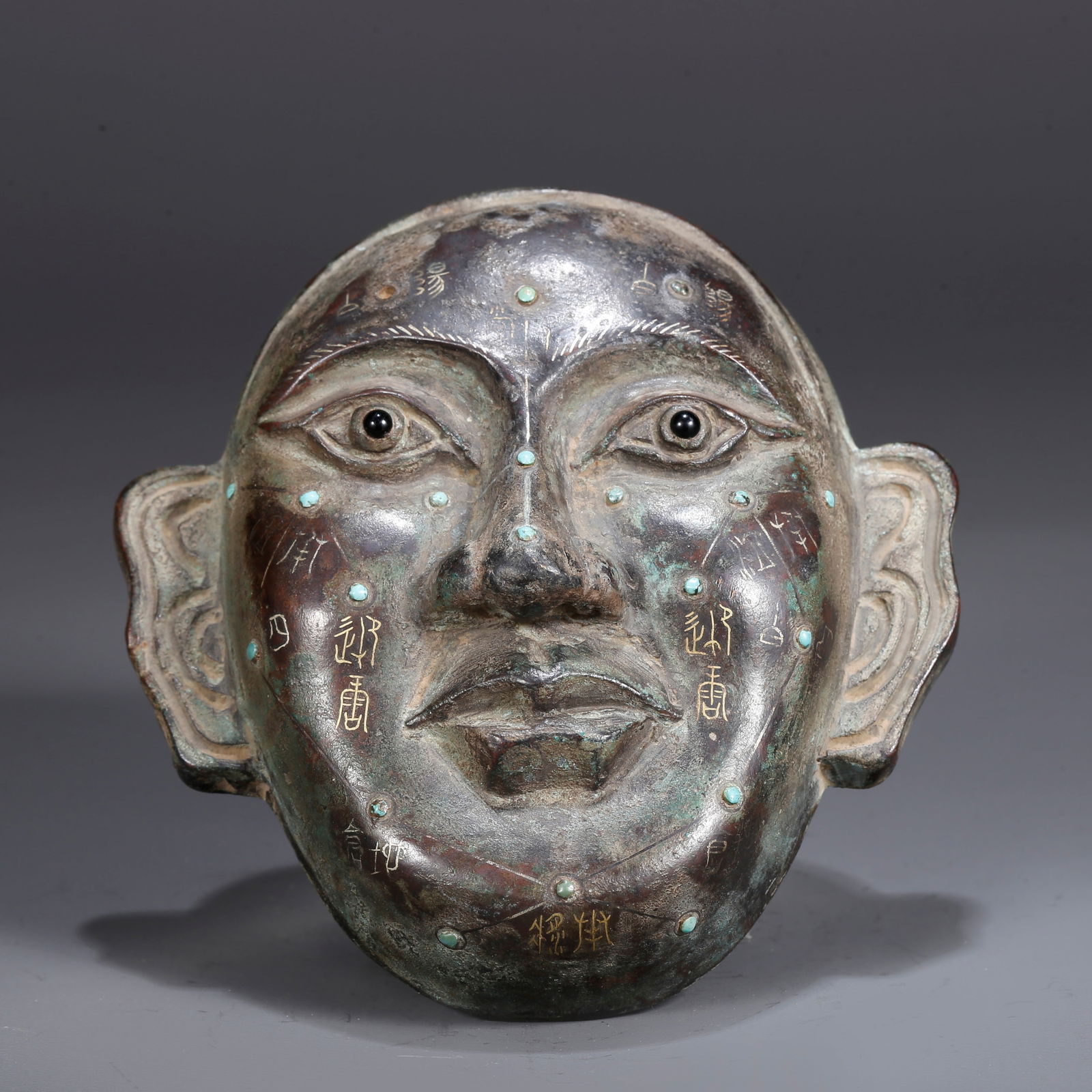 A BRONZE INLAID WITH GOLD MASK (1 of 9)