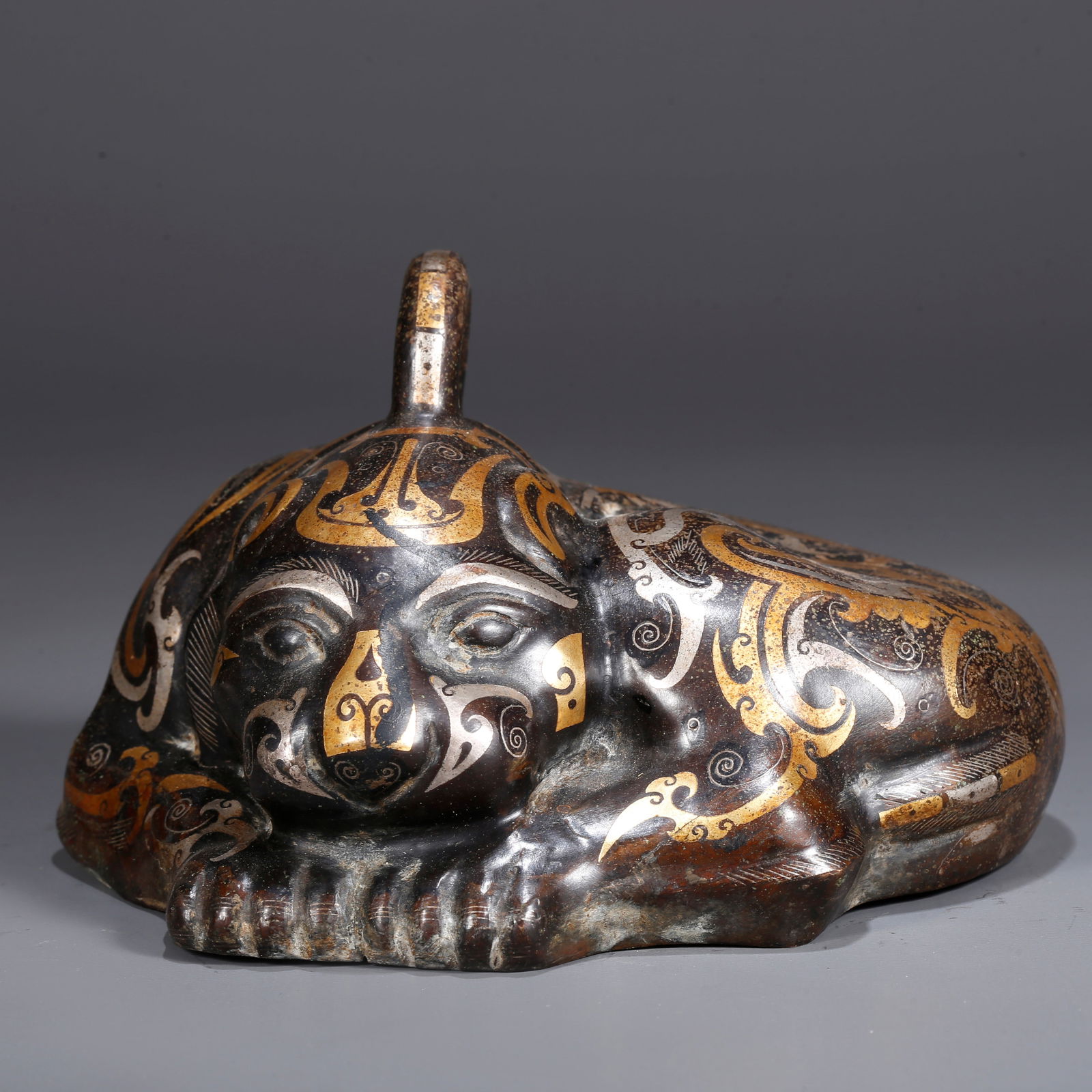 A BRONZE INLAID WITH GOLD AND SILVER CHI TIGER-SHAPED PENDANT: Bronze Inlaid with Gold and Silver Chi Tiger-Shaped Pendant