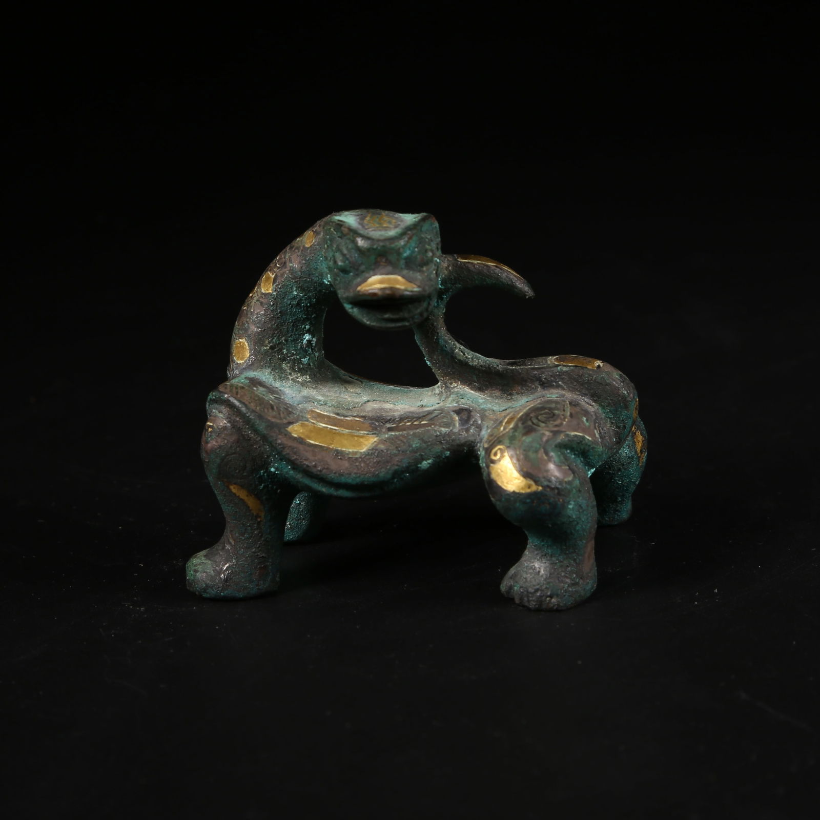 A GILT-AND-INLAID BRONZE AUSPICIOUS BEAST: Gilt-and-inlaid bronze auspicious beast