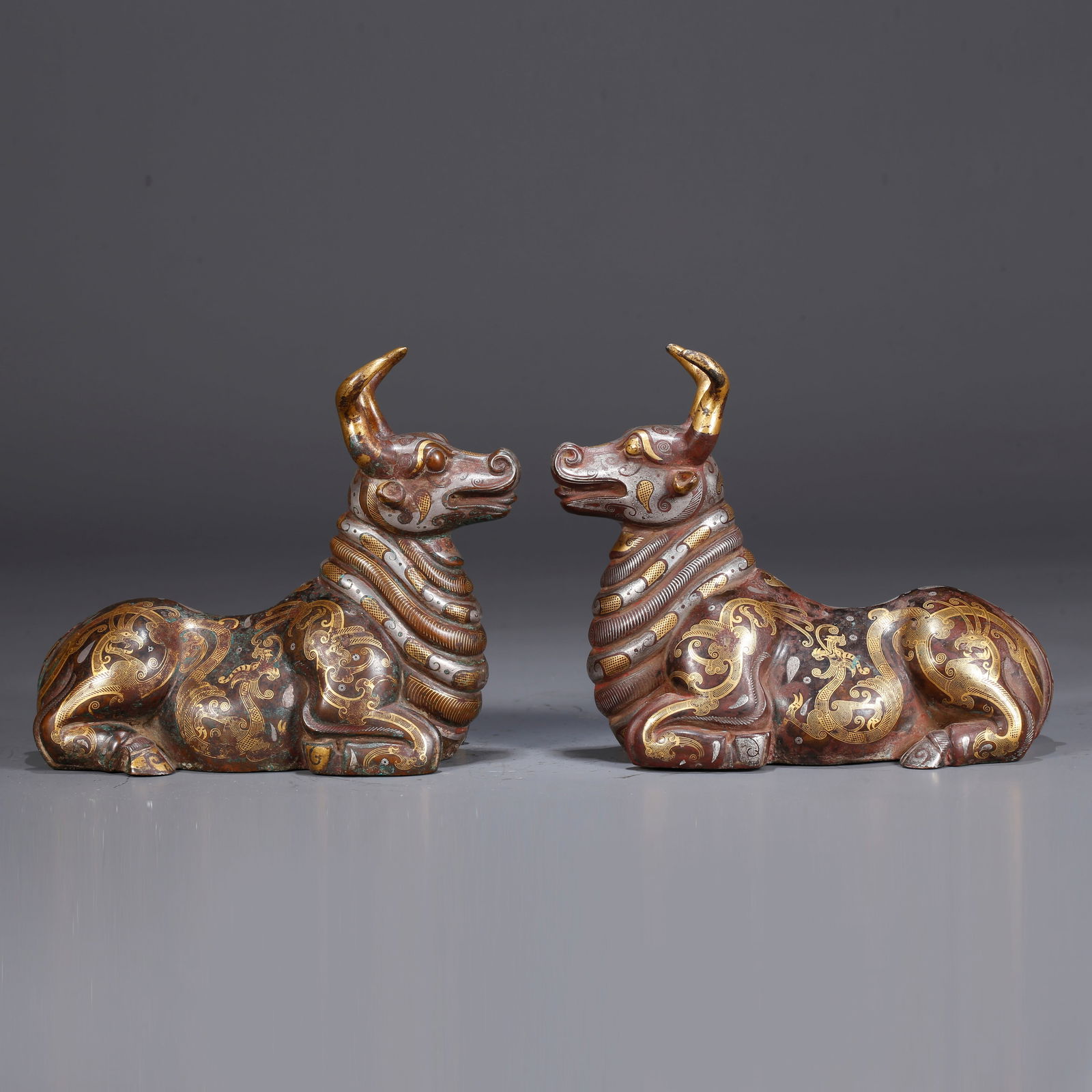 A PAIR OF BRONZE INLAID WITH GOLD AND SILVER AUSPICIOUS BEAST FIGURINES: Pair of Bronze Inlaid with Gold and Silver Auspicious Beast Figurines