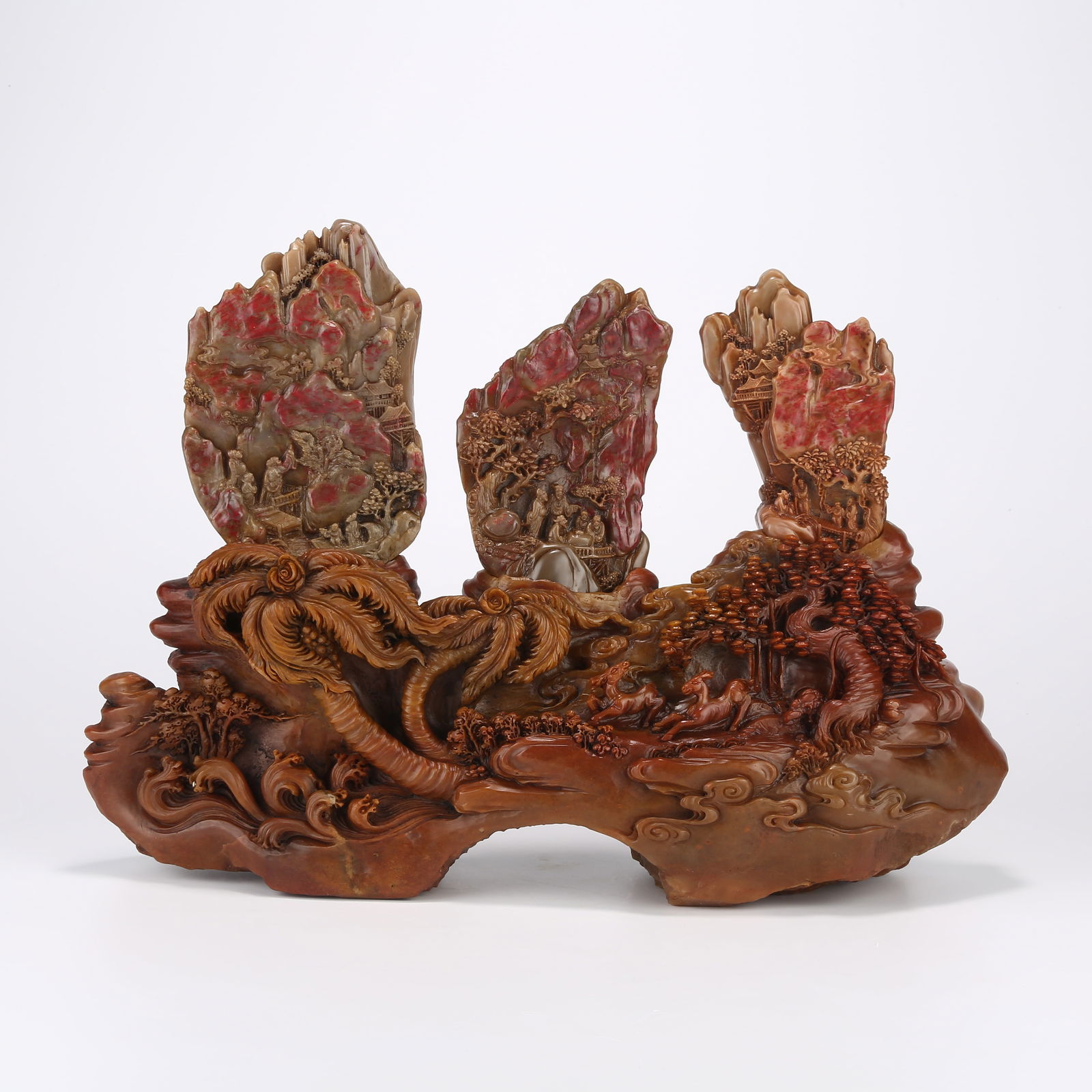 A CHICKEN BLOOD STONE MOUNTAIN-SHAPED CARVING WITH LANDSCAPE AND NARRATIVE FIGURES: Chicken Blood Stone Mountain-Shaped Carving with Landscape and Narrative Figures