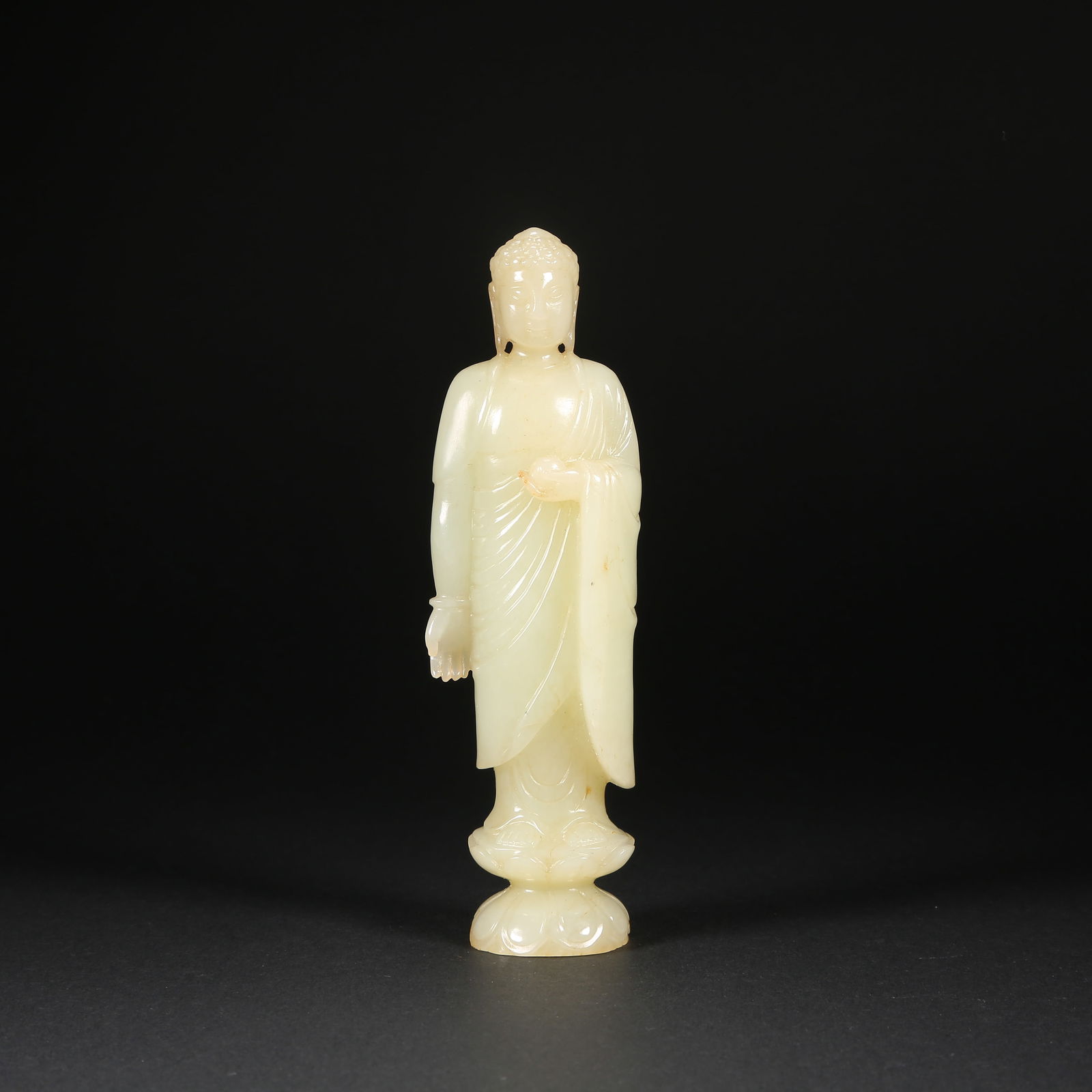 A HETIAN JADE STANDING SHAKYAMUNI ON LOTUS PEDESTAL: Hetian jade standing Shakyamuni on lotus pedestal