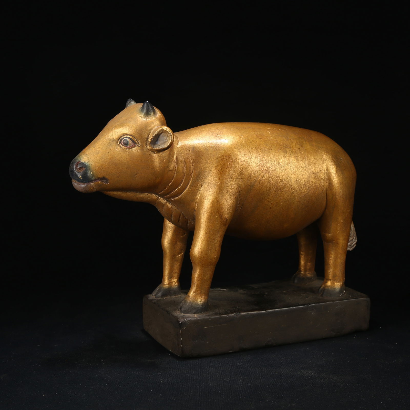 A BLACK STONE GILT DIVINE BULL ORNAMENT: Black Stone Gilt Divine Bull Ornament