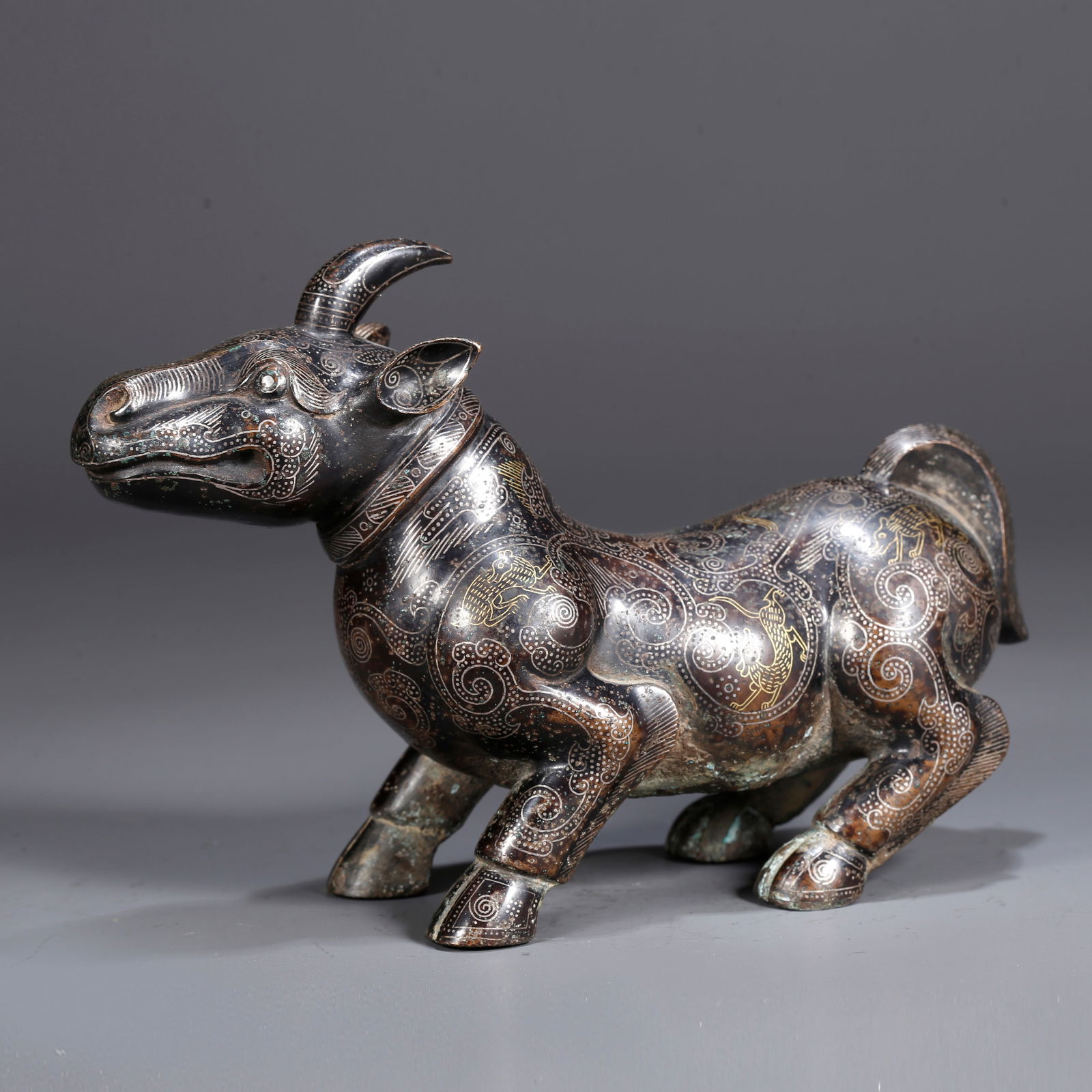A BRONZE INLAID WITH GOLD AND SILVER AUSPICIOUS BEAST FIGURINE: Bronze Inlaid with Gold and Silver Auspicious Beast Figurine