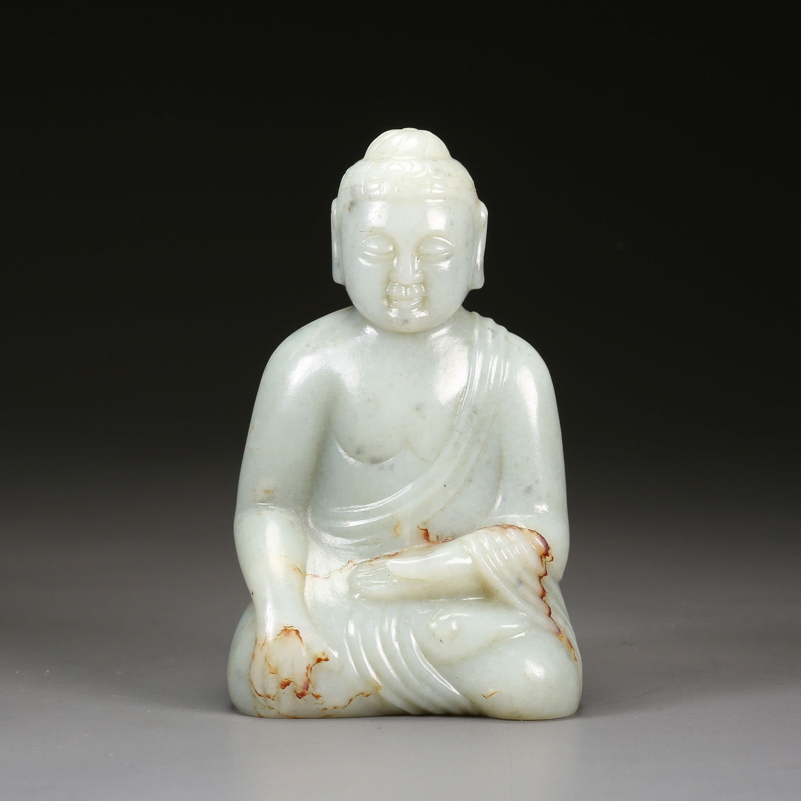 A HETIAN JADE SEATED SHAKYAMUNI BUDDHA: Hetian jade seated Shakyamuni Buddha