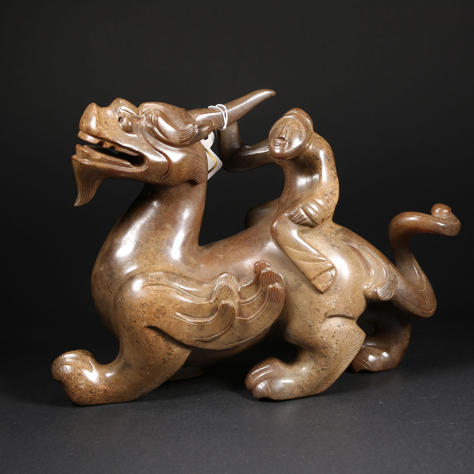 A HETIAN JADE FIGURE RIDING A BEAST: Hetian jade figure riding a beast