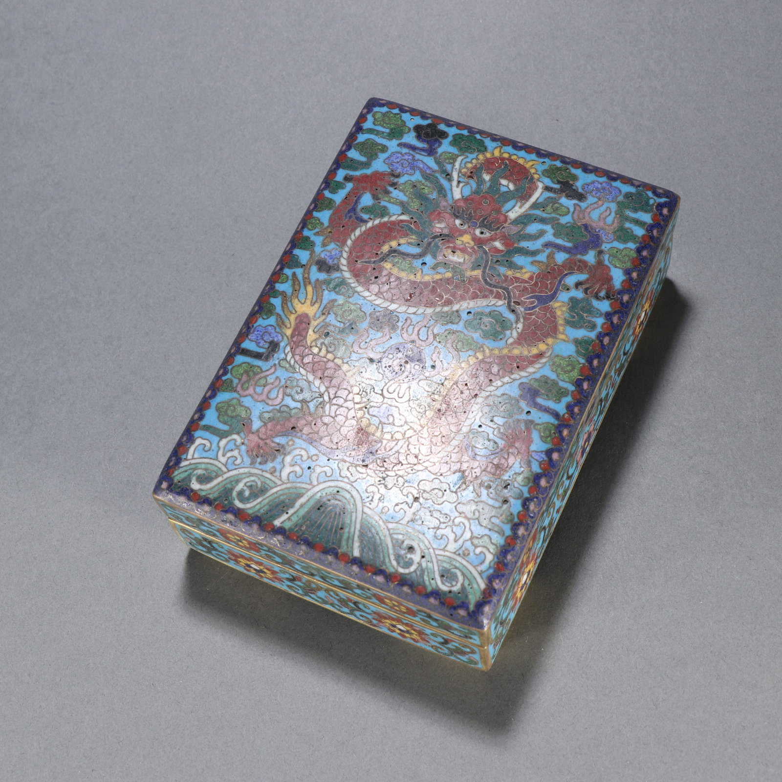 A GILDED BRONZE CLOISONNÉ COVERED BOX WITH DRAGON MOTIFS: Gilded Bronze Cloisonné Covered Box with Dragon Motifs