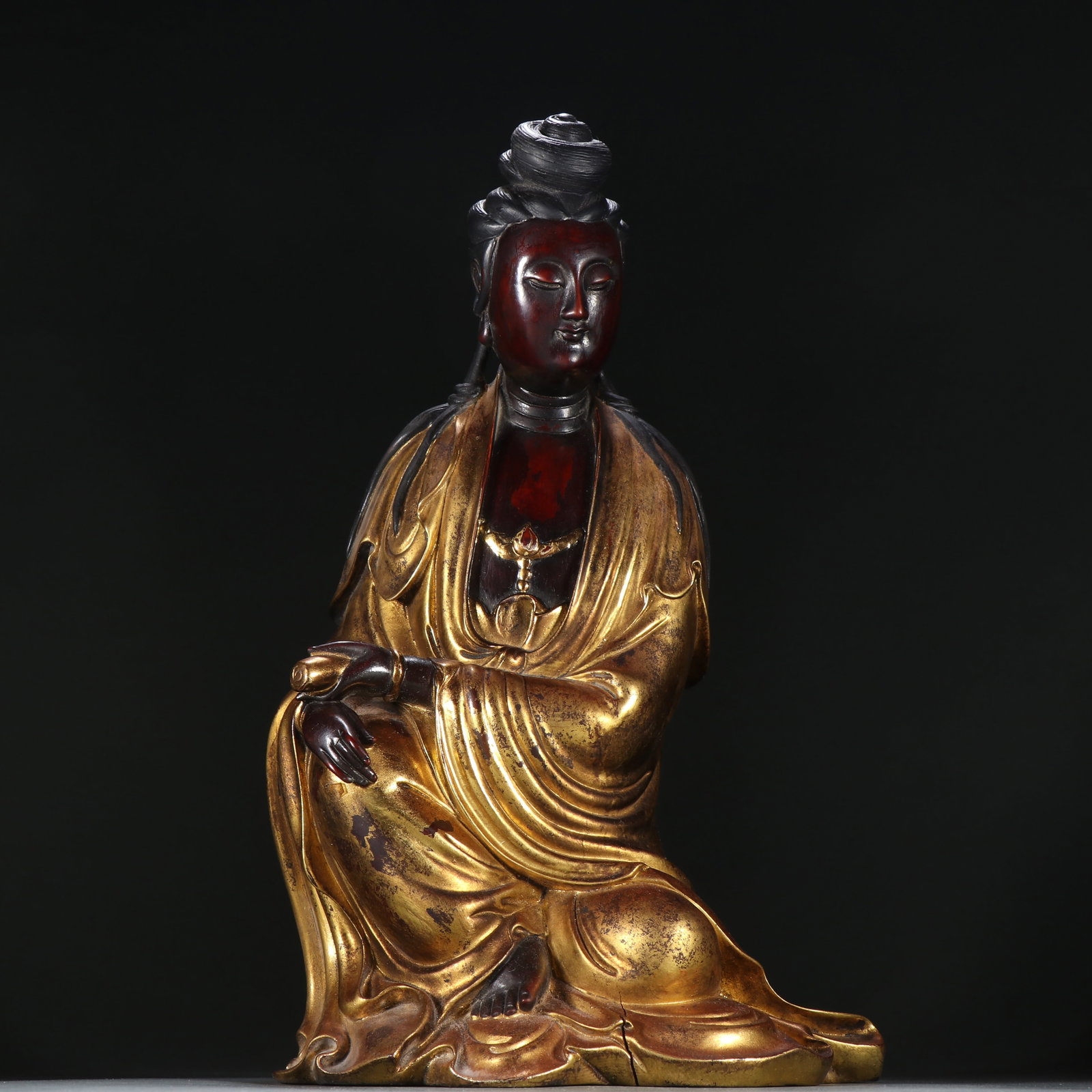 A ZITAN LACQUERED AND GILDED GUANYIN STATUE: Zitan Lacquered and Gilded Guanyin Statue