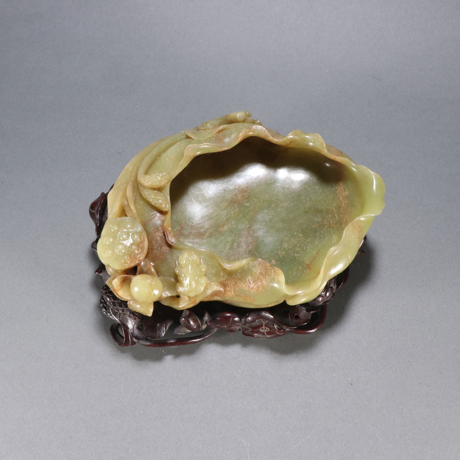 A HETIAN YELLOW JADE LOTUS-LEAF–SHAPED WASHER: Hetian Yellow Jade Lotus-Leaf–Shaped Washer
