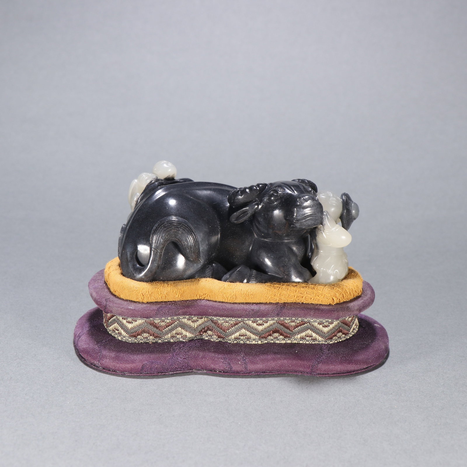 A BLUE-AND-WHITE SEED-JADE ORNAMENT OF BOY PLAYING WITH OX: Blue-and-White Seed-Jade Ornament of Boy Playing with Ox