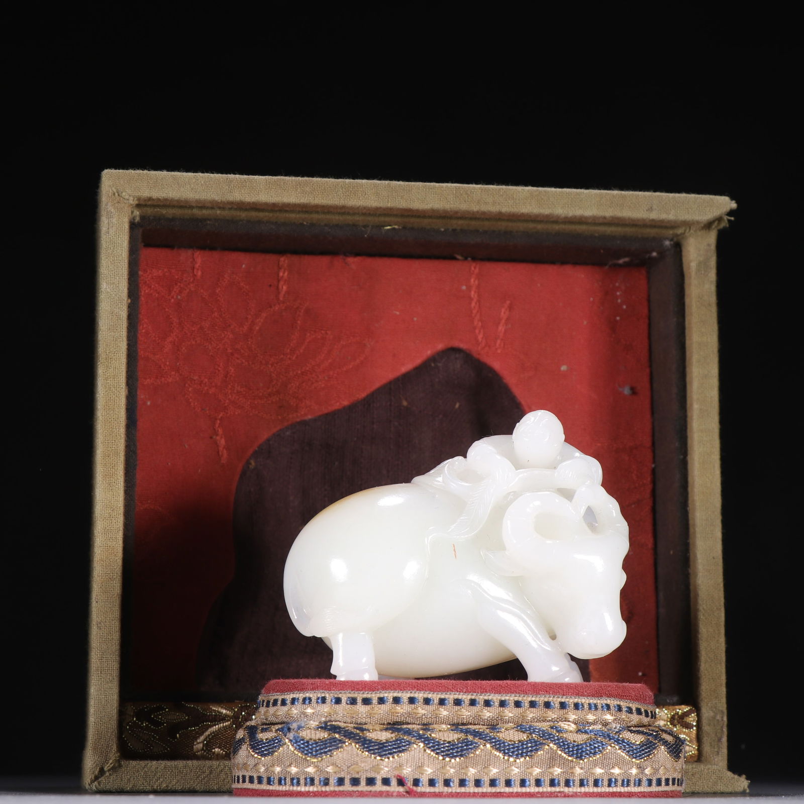 A HETIAN JADE ORNAMENT OF BOY PLAYING WITH OX: Hetian Jade Ornament of Boy Playing with Ox