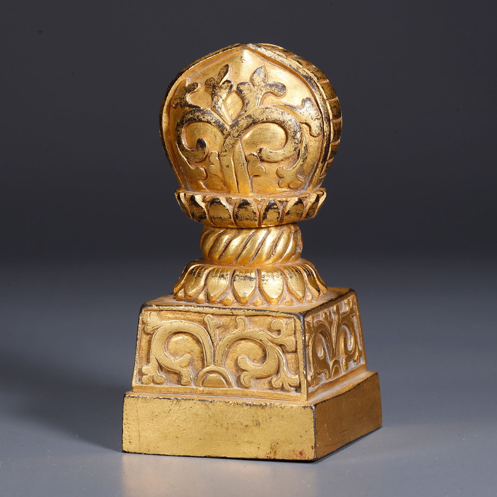 A GILDED BRONZE DHARMA WHEEL SEAL (1 of 9)