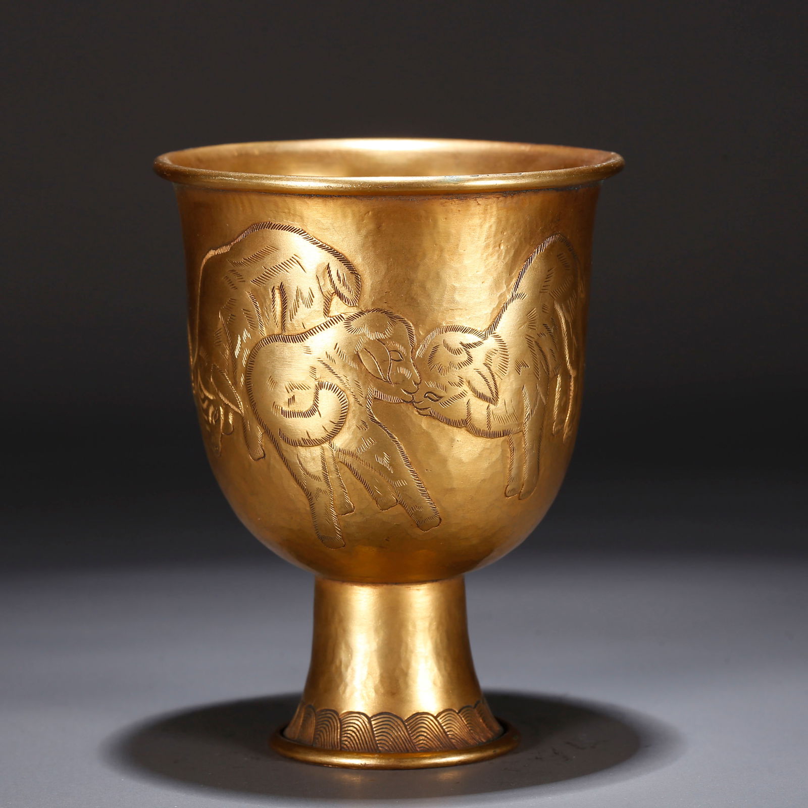 A GILT BRONZE CUP WITH RAM PATTERN: Gilt Bronze Cup with Ram Pattern