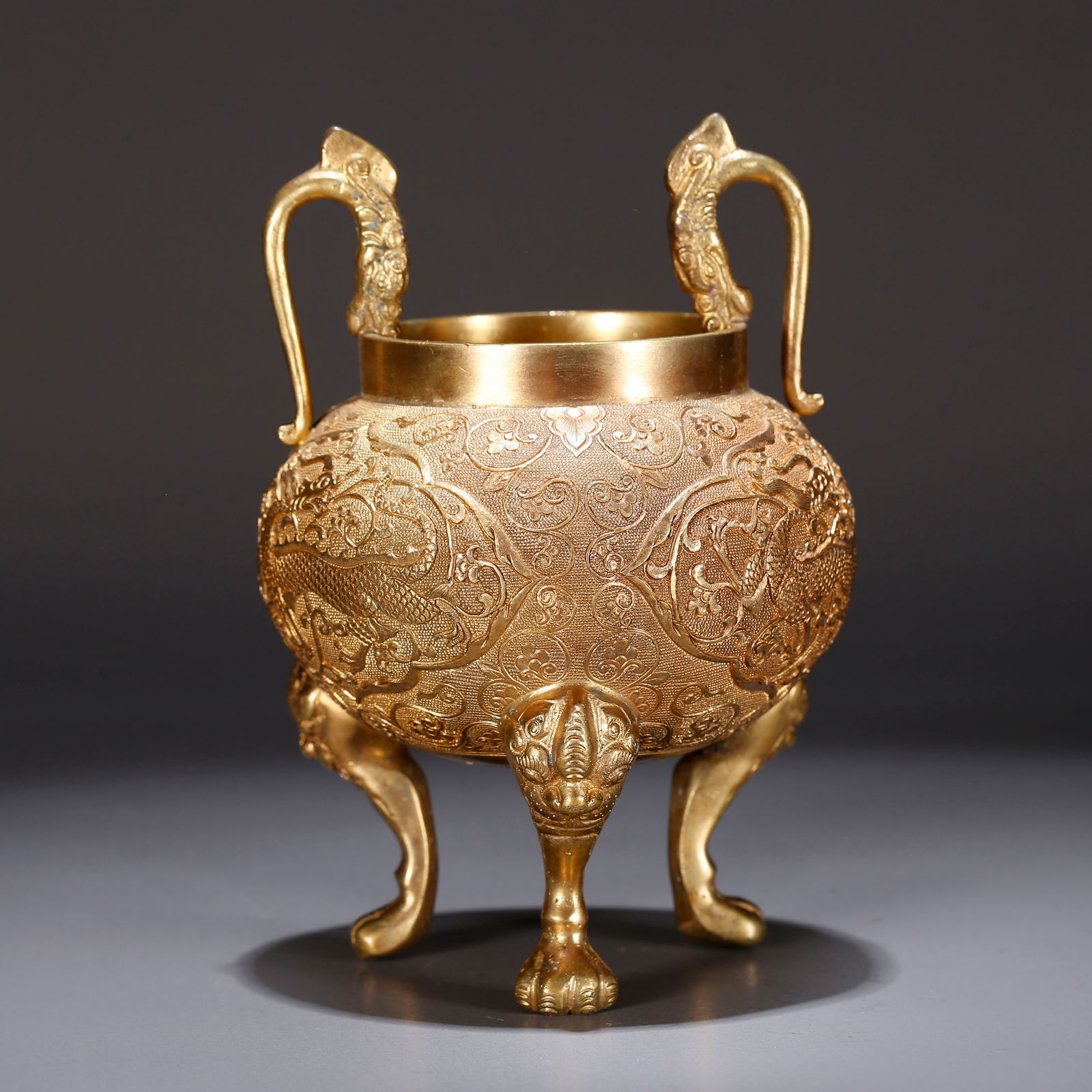 A GILT BRONZE TRIPOD CENSER WITH CLOUD AND DRAGON PATTERN (1 of 9)