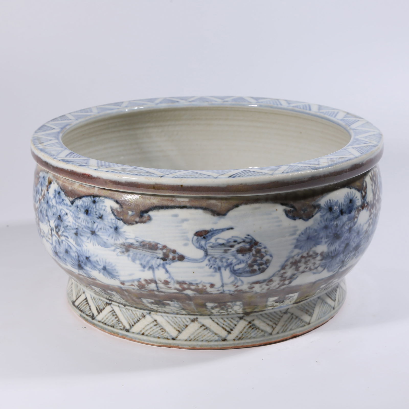 A BLUE-AND-WHITE UNDERGLAZE-RED JAR WITH PINE AND CRANE LONGEVITY PATTERN: Blue-and-White Underglaze-Red Jar with Pine and Crane Longevity Pattern