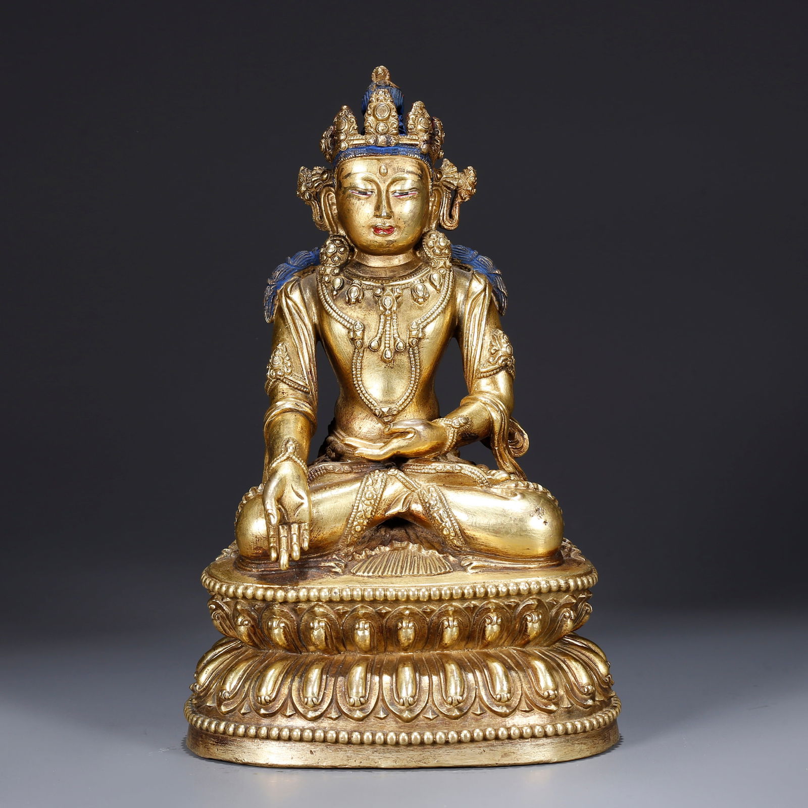 A GILDED BRONZE STATUE OF SHAKYAMUNI WITH JEWELED CROWN: Gilded Bronze Statue of Shakyamuni with Jeweled Crown