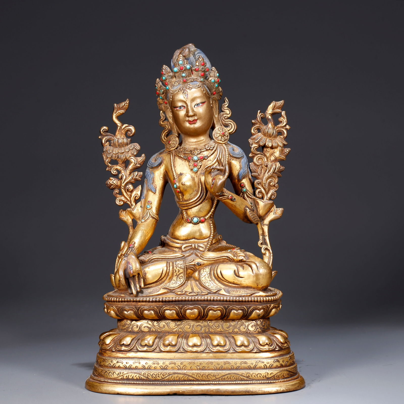 A GILDED BRONZE STATUE OF AVALOKITESHVARA HOLDING A LOTUS (1 of 9)