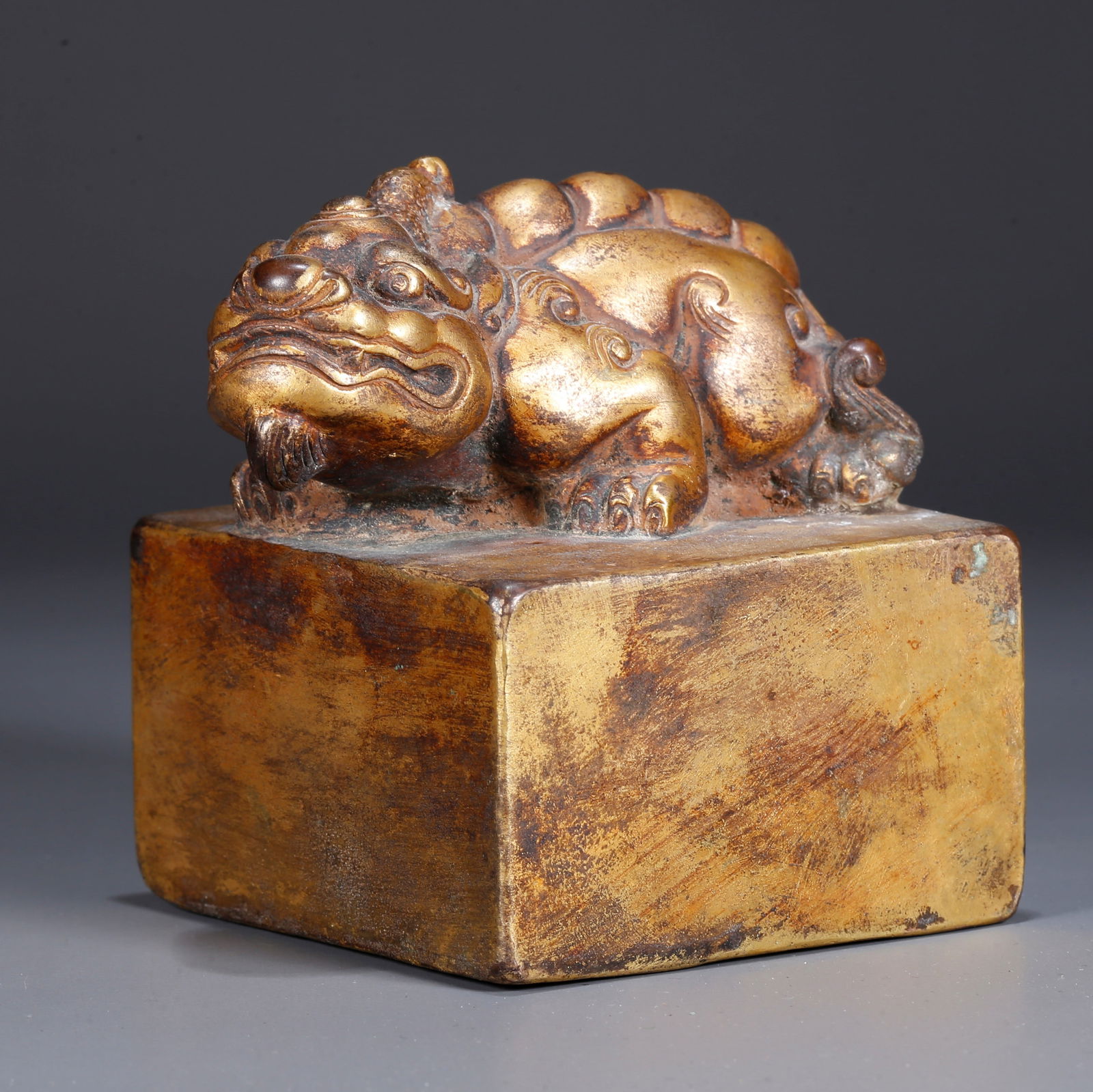 A GILDED BRONZE BEAST-BUTTON SEAL (1 of 11)