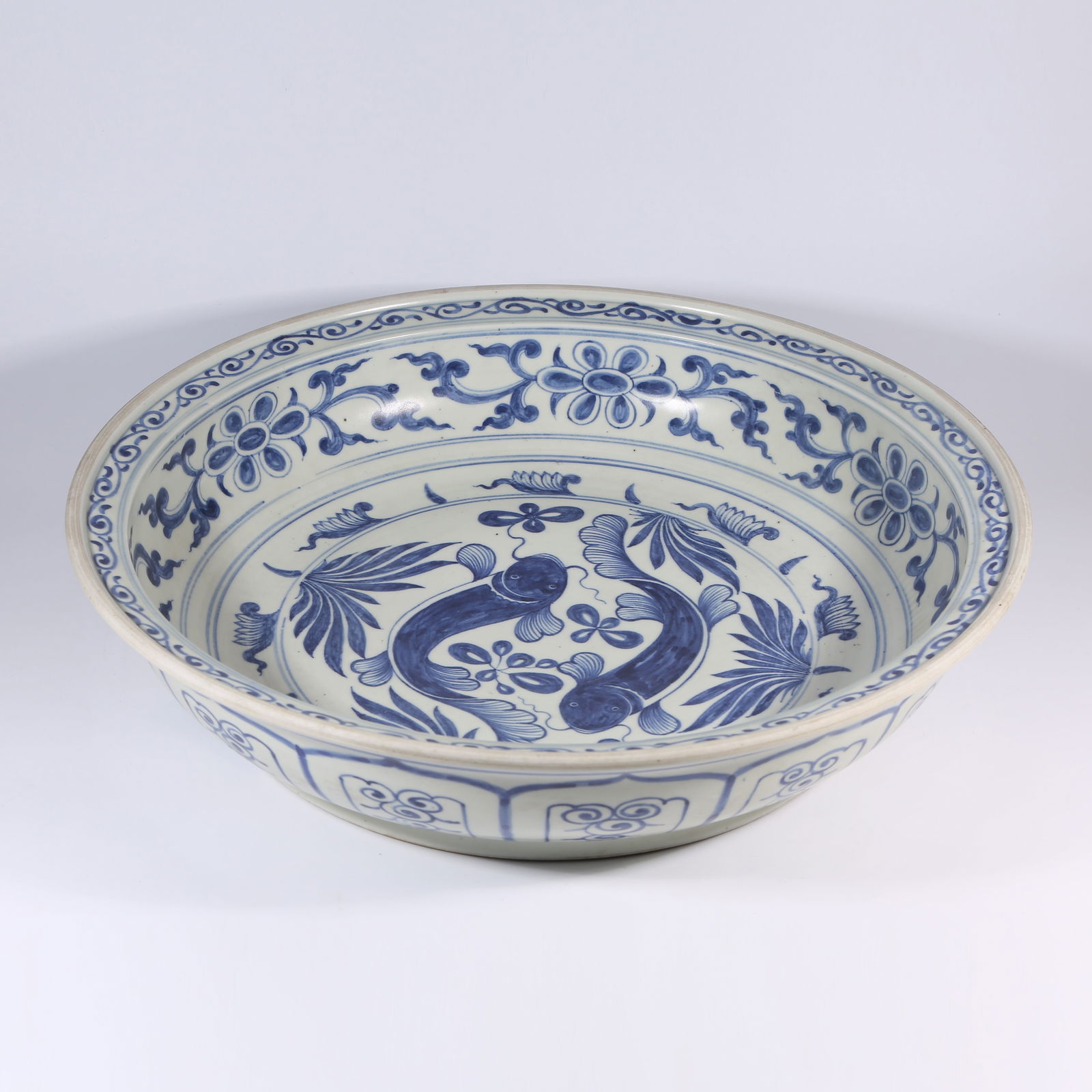 A BLUE-AND-WHITE FOLDED-RIM DISH WITH FISH AND ALGAE PATTERN: Blue-and-White Folded-Rim Dish with Fish and Algae Pattern