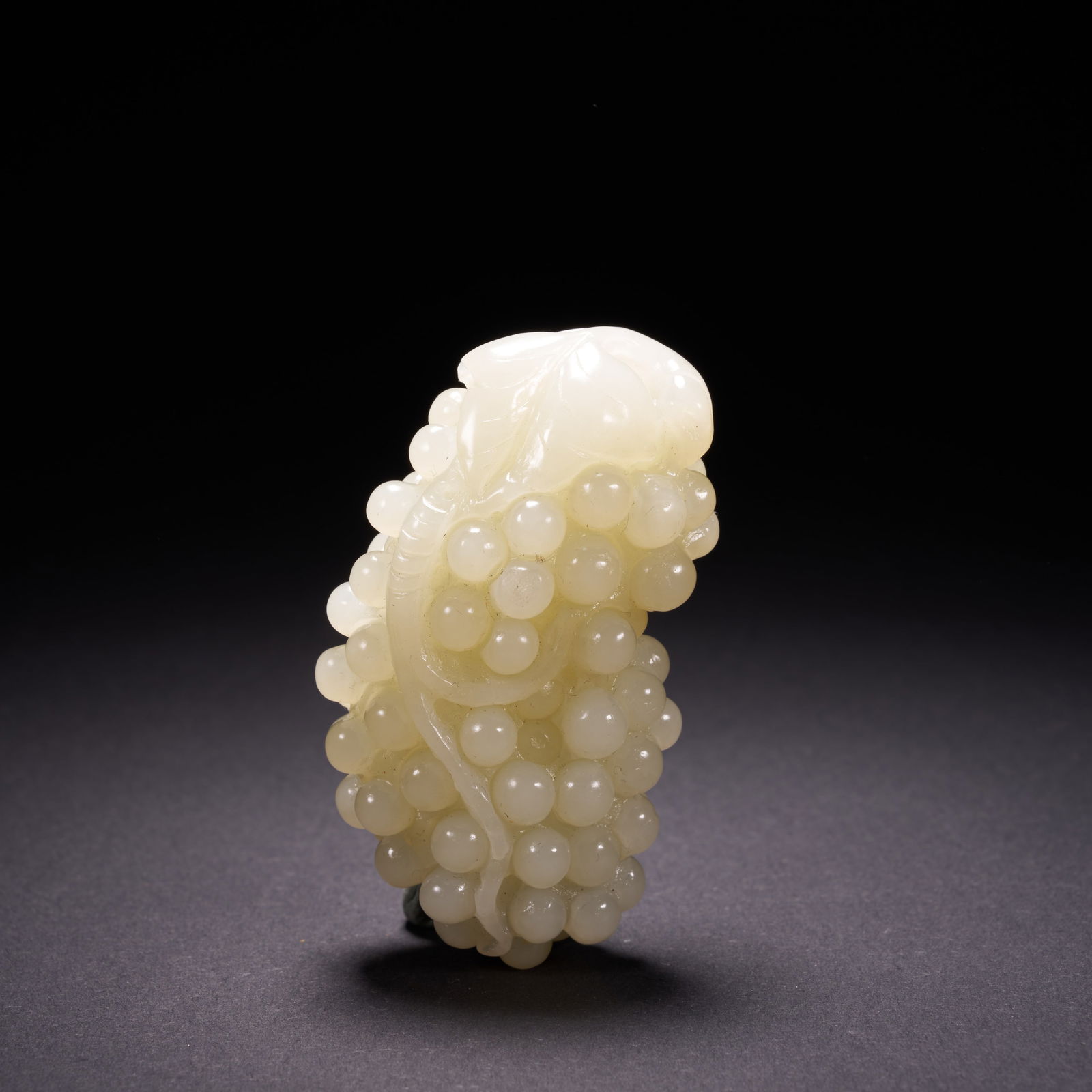 A HETIAN JADE GRAPE HAND-HELD CARVING, QING DYNASTY (1 of 7)
