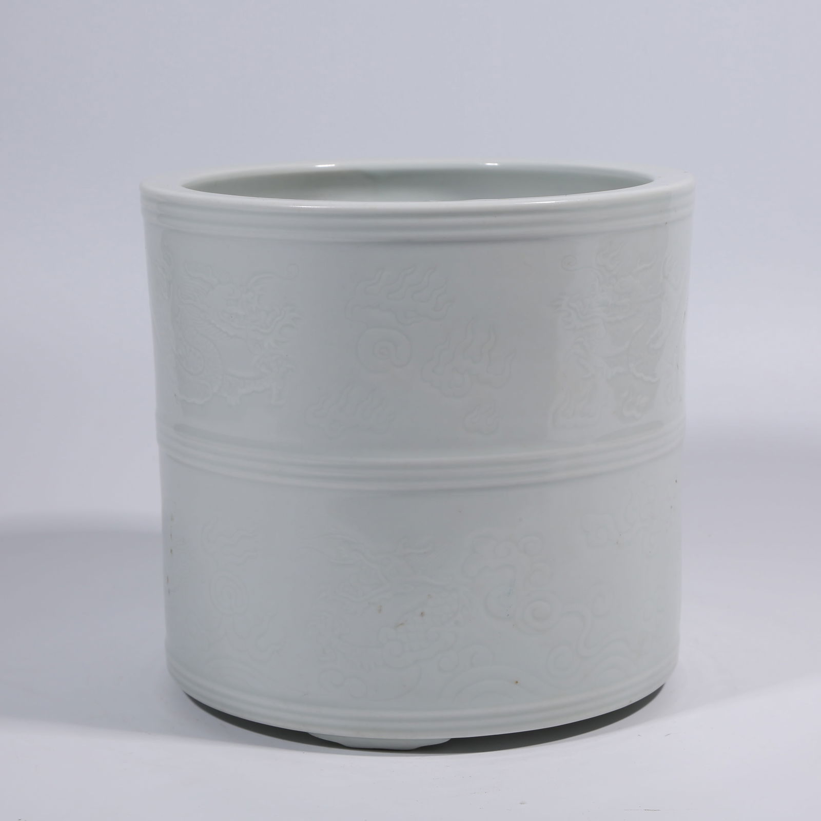 A WHITE-GLAZE BRUSH POT WITH INCISED DRAGON PATTERN: White-Glaze Brush Pot with Incised Dragon Pattern
