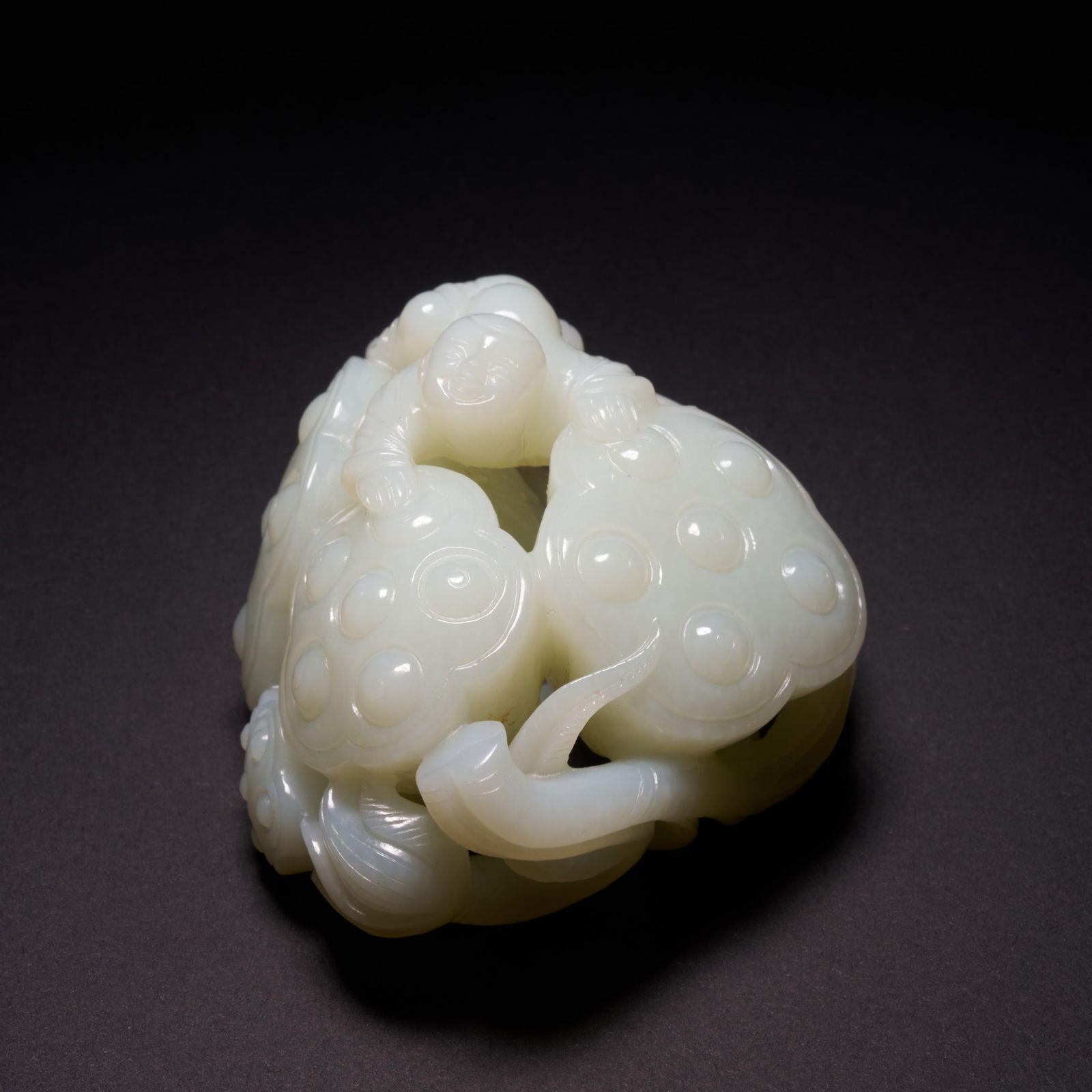 A HETIAN JADE "BOY WITH LOTUS ROOT" HAND-HELD CARVING, QING DYNASTY (1 of 10)