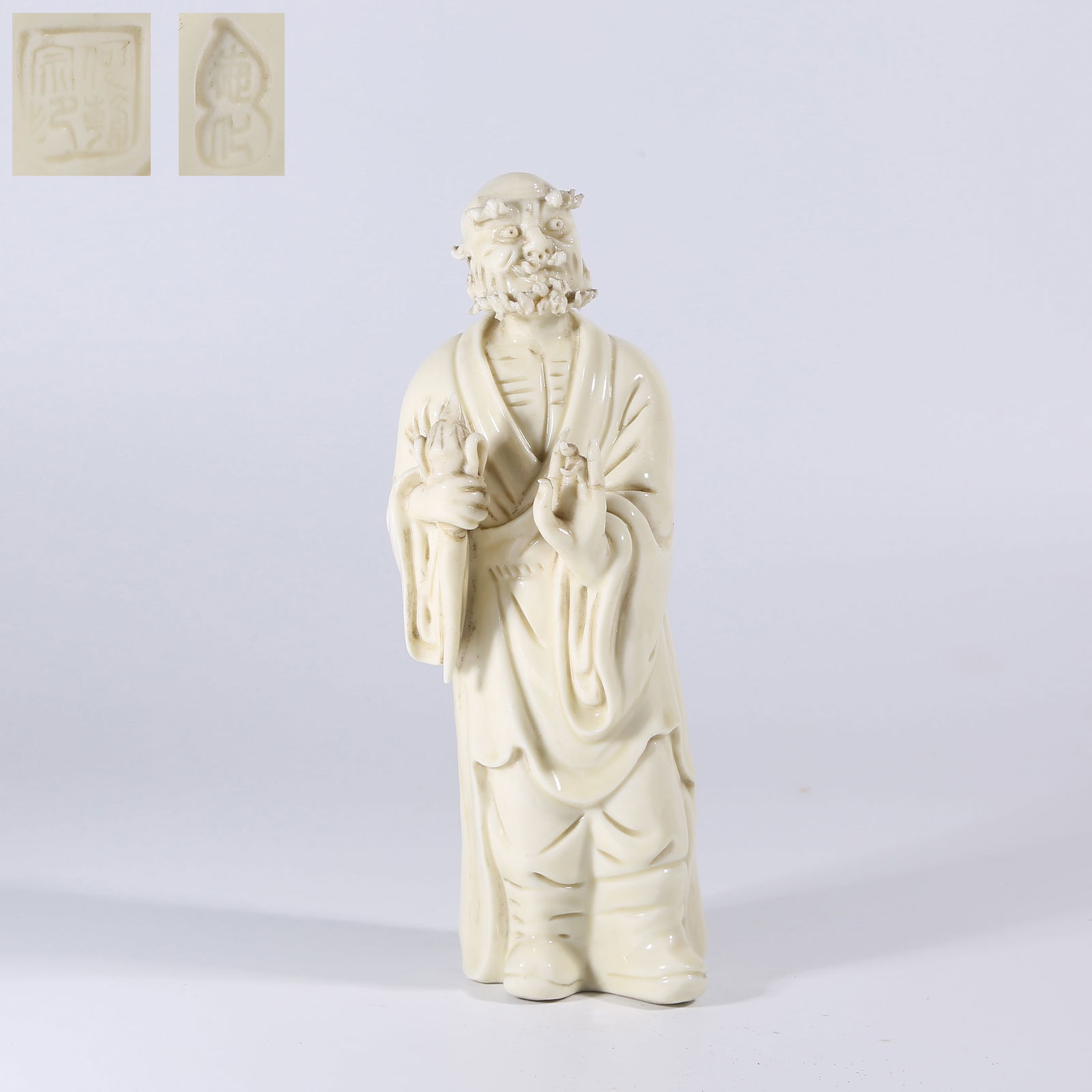 A WHITE PORCELAIN DARUMA STATUE: White Porcelain Daruma Statue