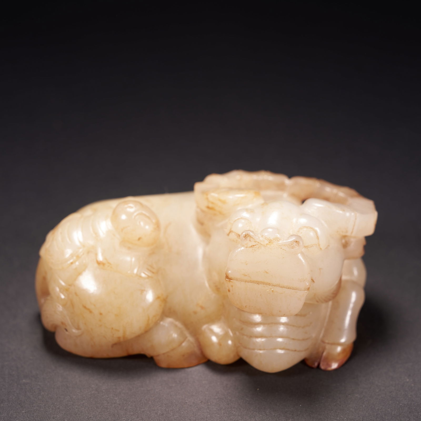 A HETIAN JADE "BOY PLAYING WITH AN OX" ORNAMENT, QING DYNASTY (1 of 9)