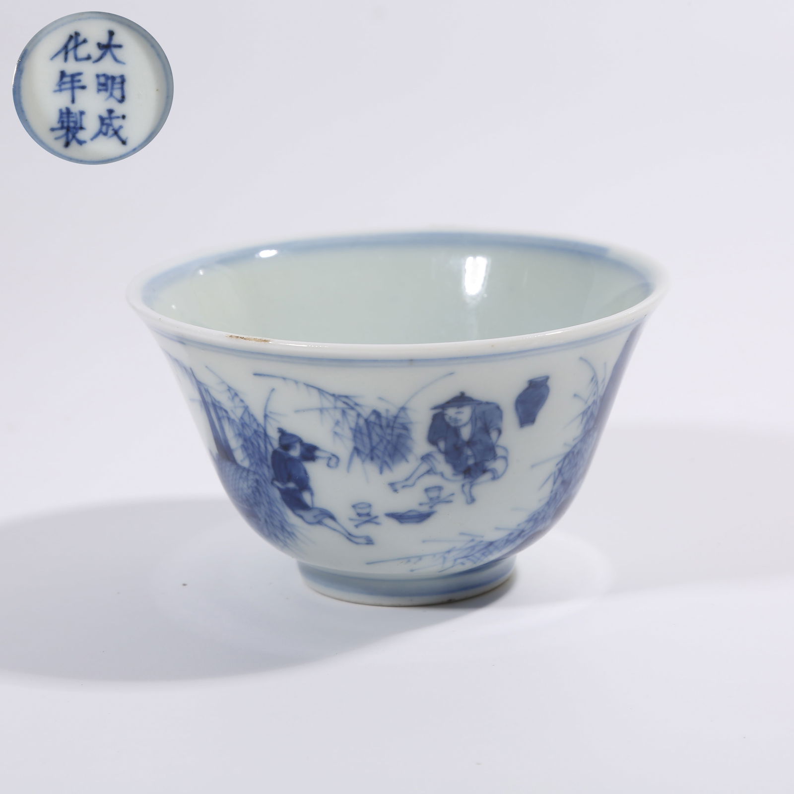 A QING DYNASTY KANGXI BLUE-AND-WHITE CUP WITH FISHING AND LEISURE SCENE (1 of 9)