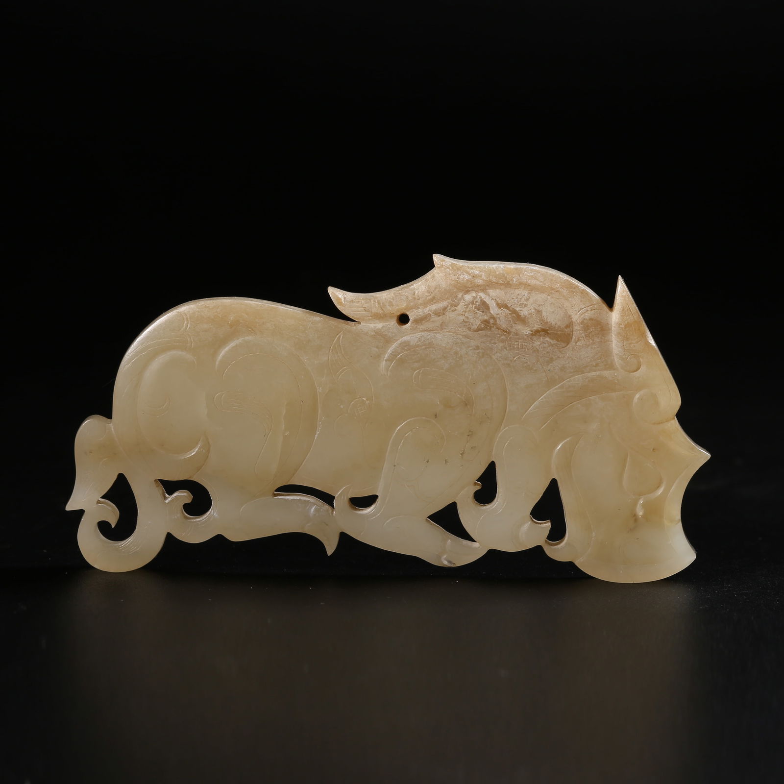 A HIGH-ANTIQUITY JADE AUSPICIOUS BEAST PENDANT (1 of 9)